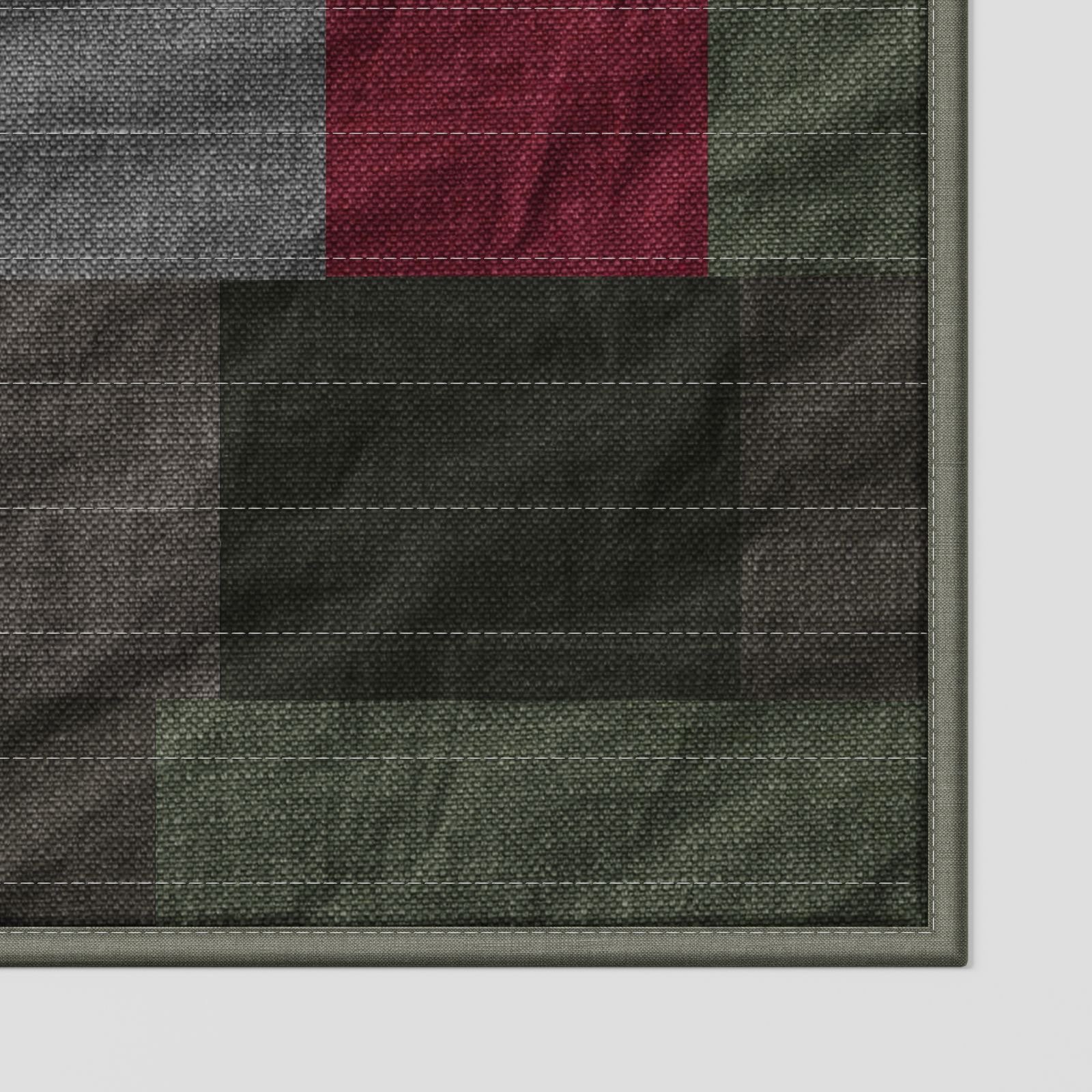 Foxlow patchwork quilt in earthy green, olive, grey and muted red tones, close-up detail highlighting textured fabric, stitching lines and layered patchwork panels