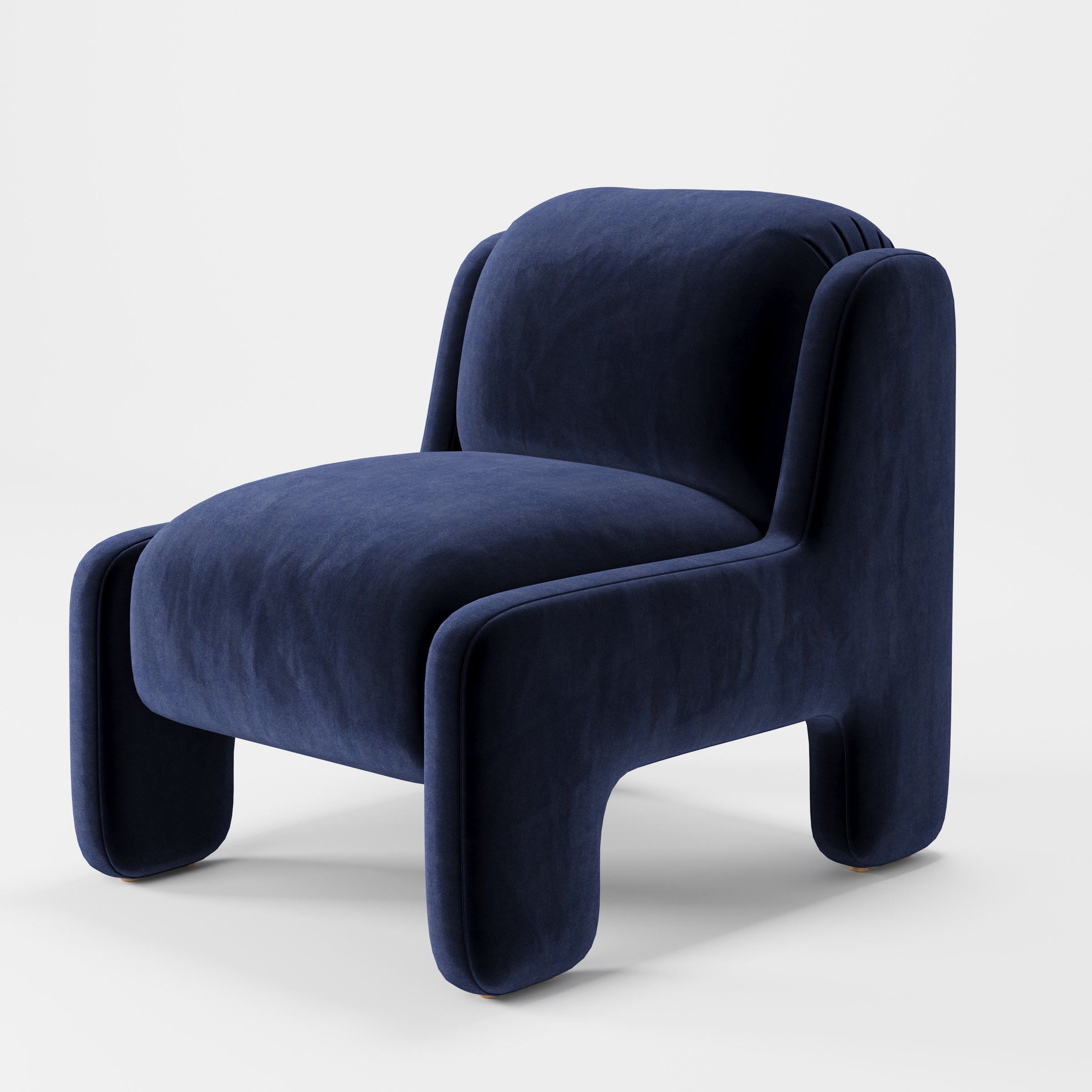 Inny armchair in Noss Velvet Navy shown at a diagonal angle highlighting sculpted form and low seat.