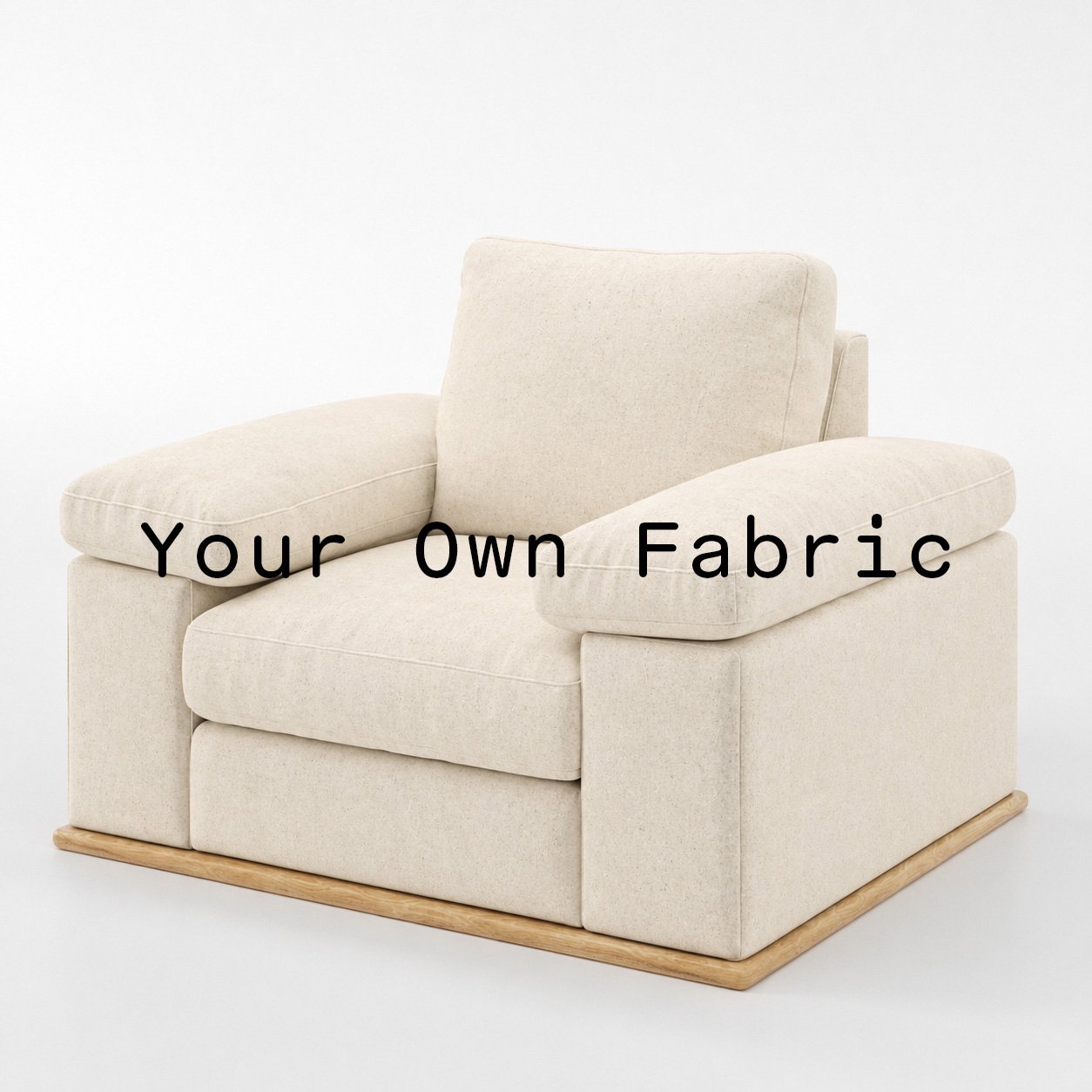 Diagonal view of the Cusher armchair upholstered in customers own material calico cotton fabric.