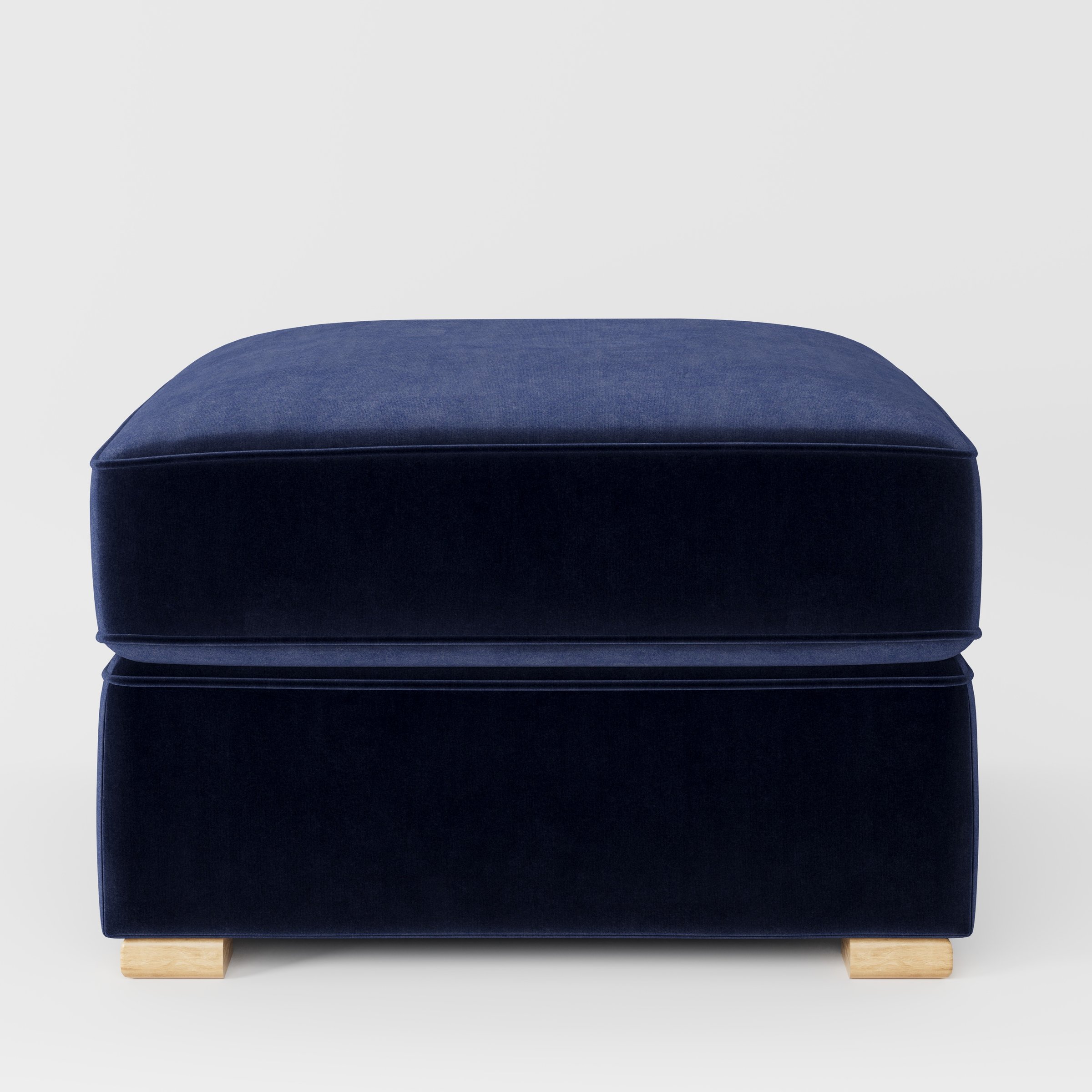 Cashel footstool in Noss Velvet Navy shown front-on against a neutral studio backdrop.