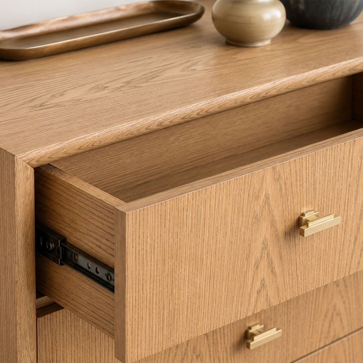 Close-up of Chest of Drawers 02 in natural oak showing the open drawer, brass handle and drawer runner detail