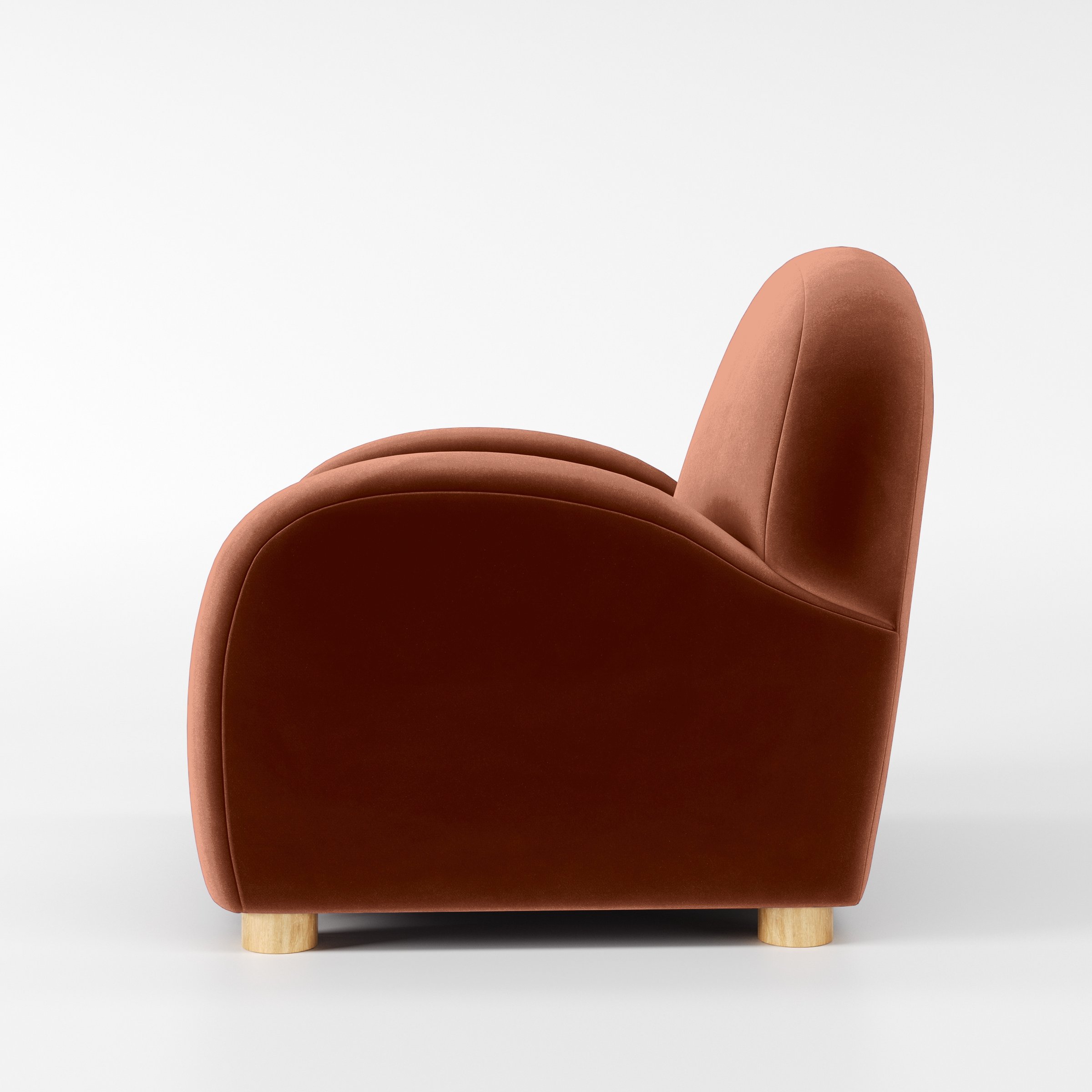 Side view of the Awe armchair upholstered in Plush EasyClean Velvet in Apricot.