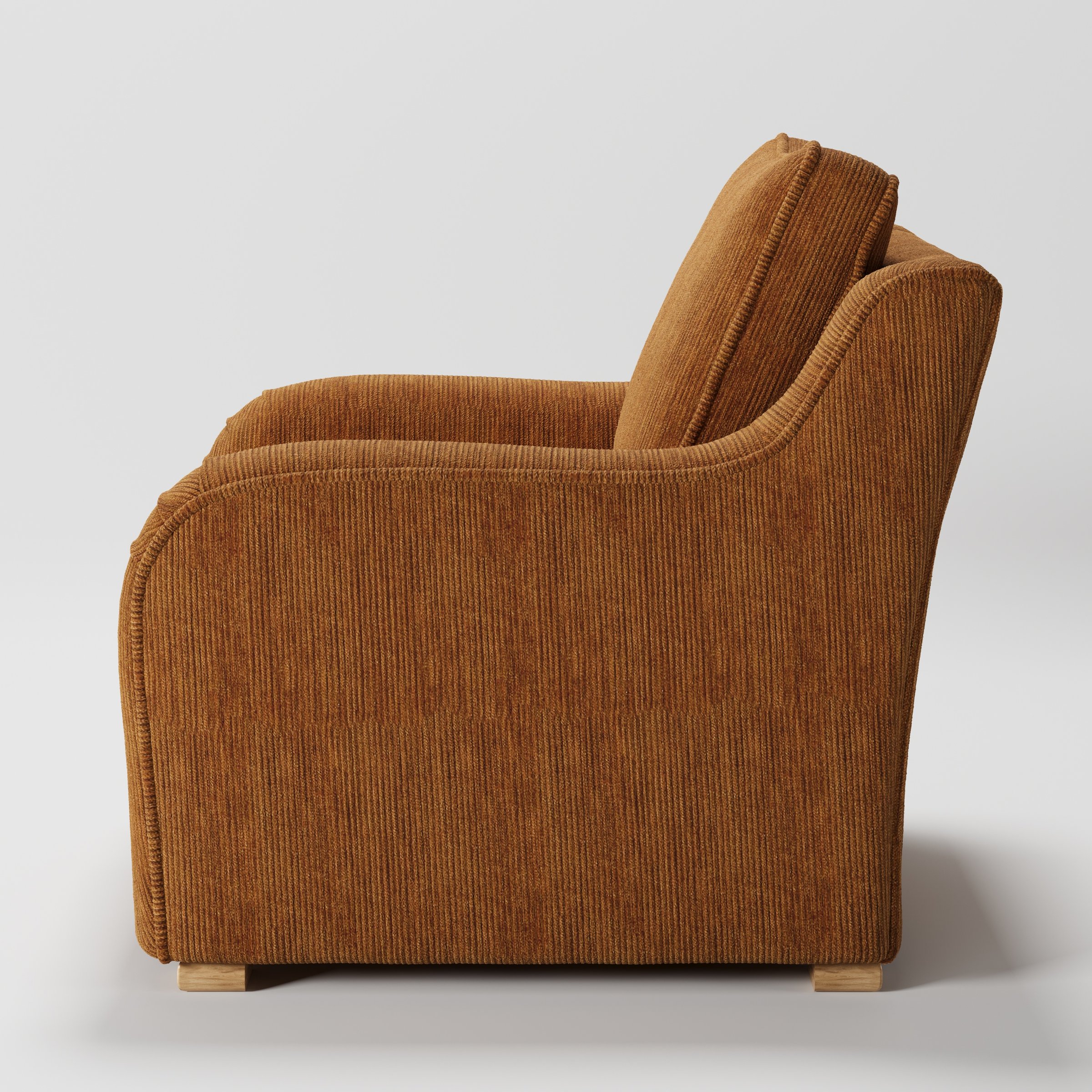 Cashel armchair in Caldey Velvet Corduroy Tobacco shown in side profile displaying proportions and overall silhouette.