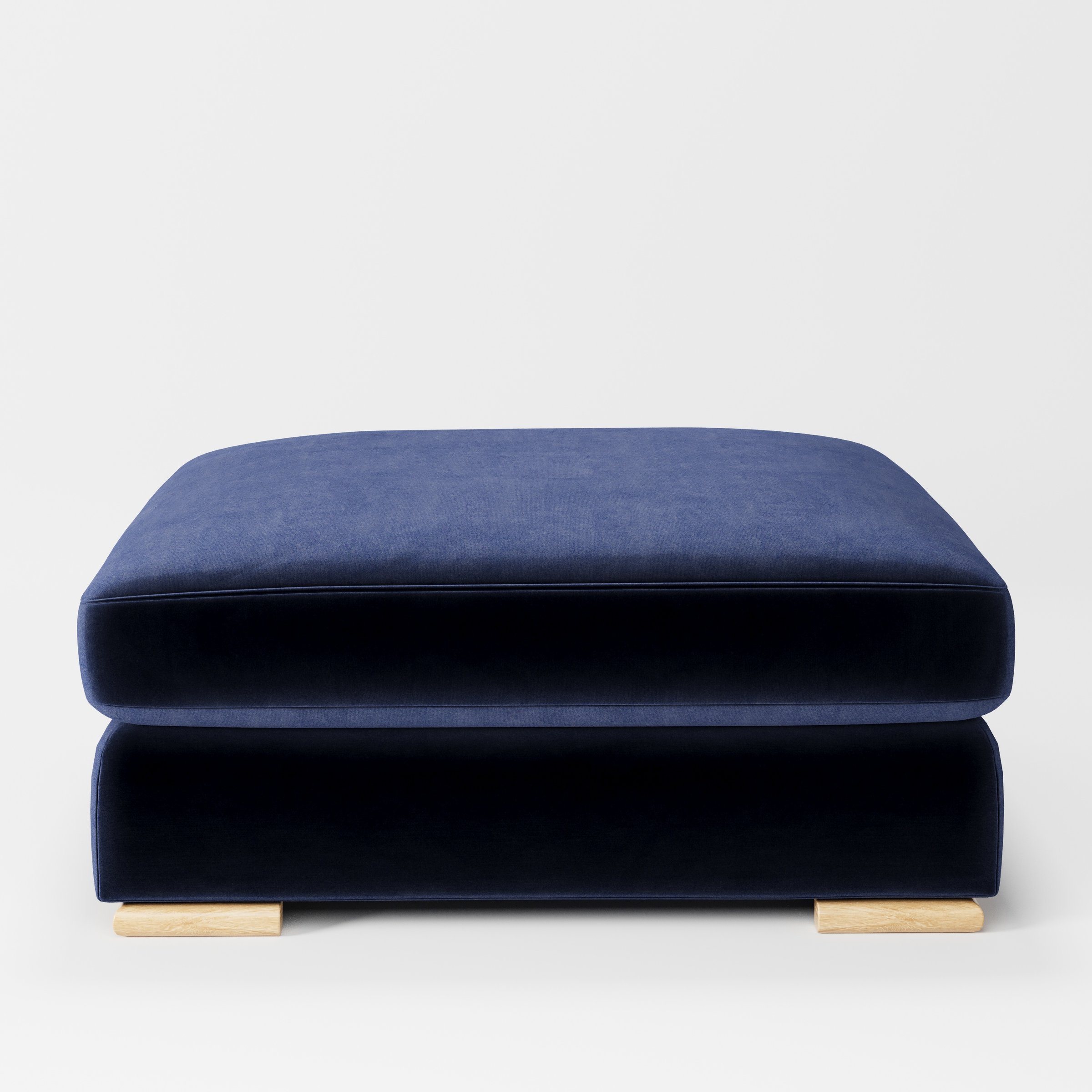 Olton footstool in Noss Velvet Navy shown front-on against a neutral studio backdrop.