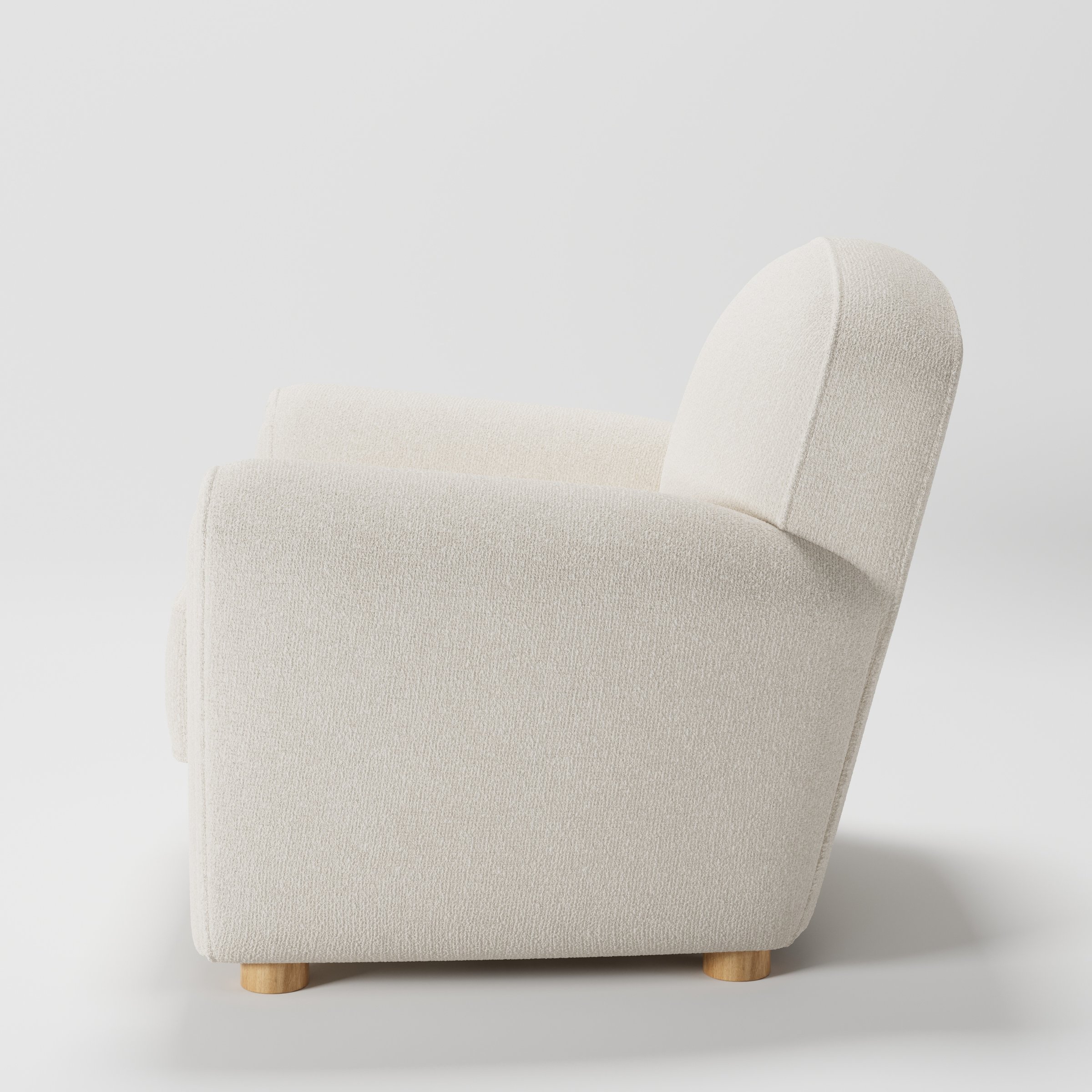 Fergus armchair in Kilda Boucle Cream shown in side profile displaying proportions and overall silhouette.