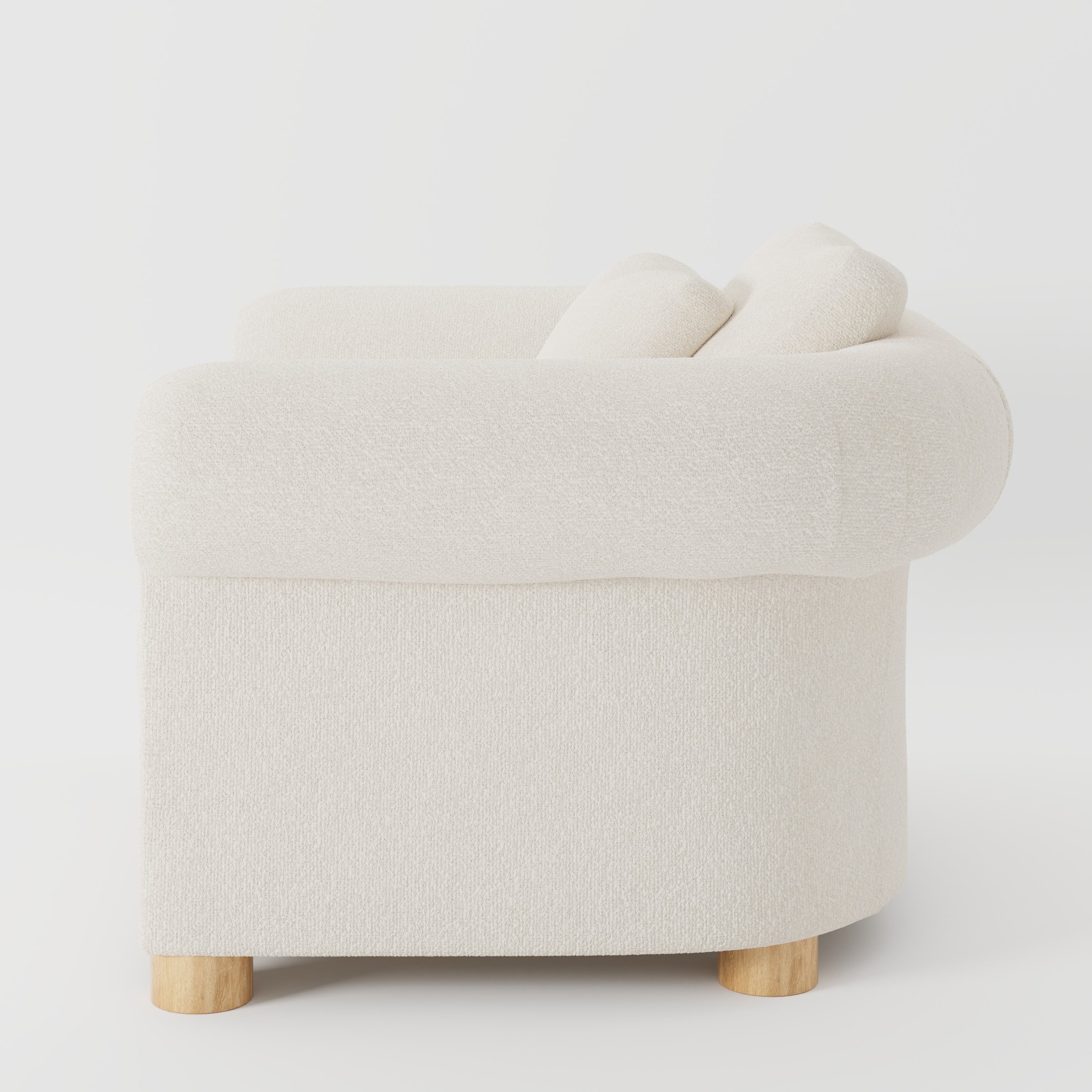 Windermere armchair in Kilda Boucle Cream shown in side profile displaying proportions and overall silhouette.