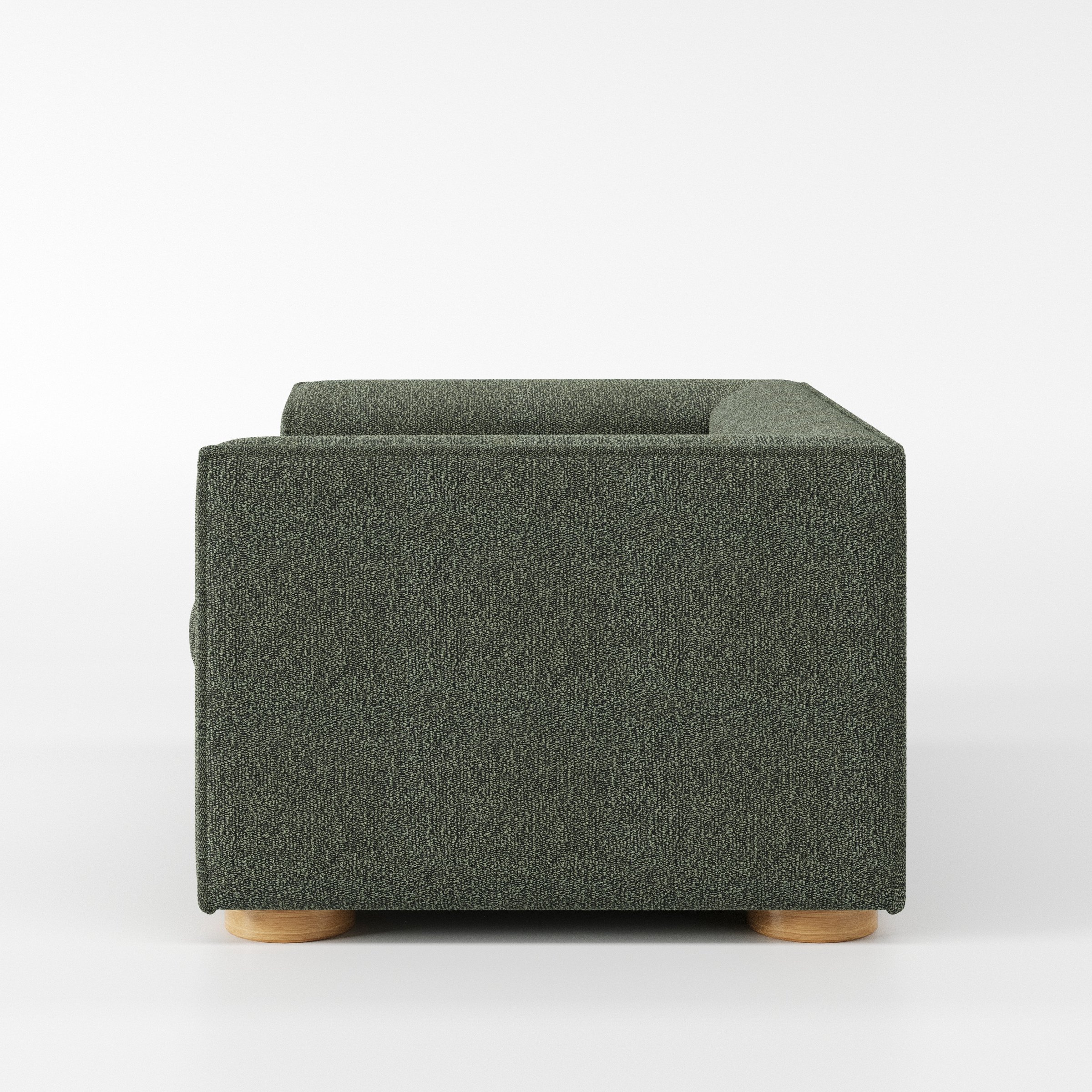 Feale armchair in Kilda Boucle Moss shown in side profile displaying proportions and overall silhouette.
