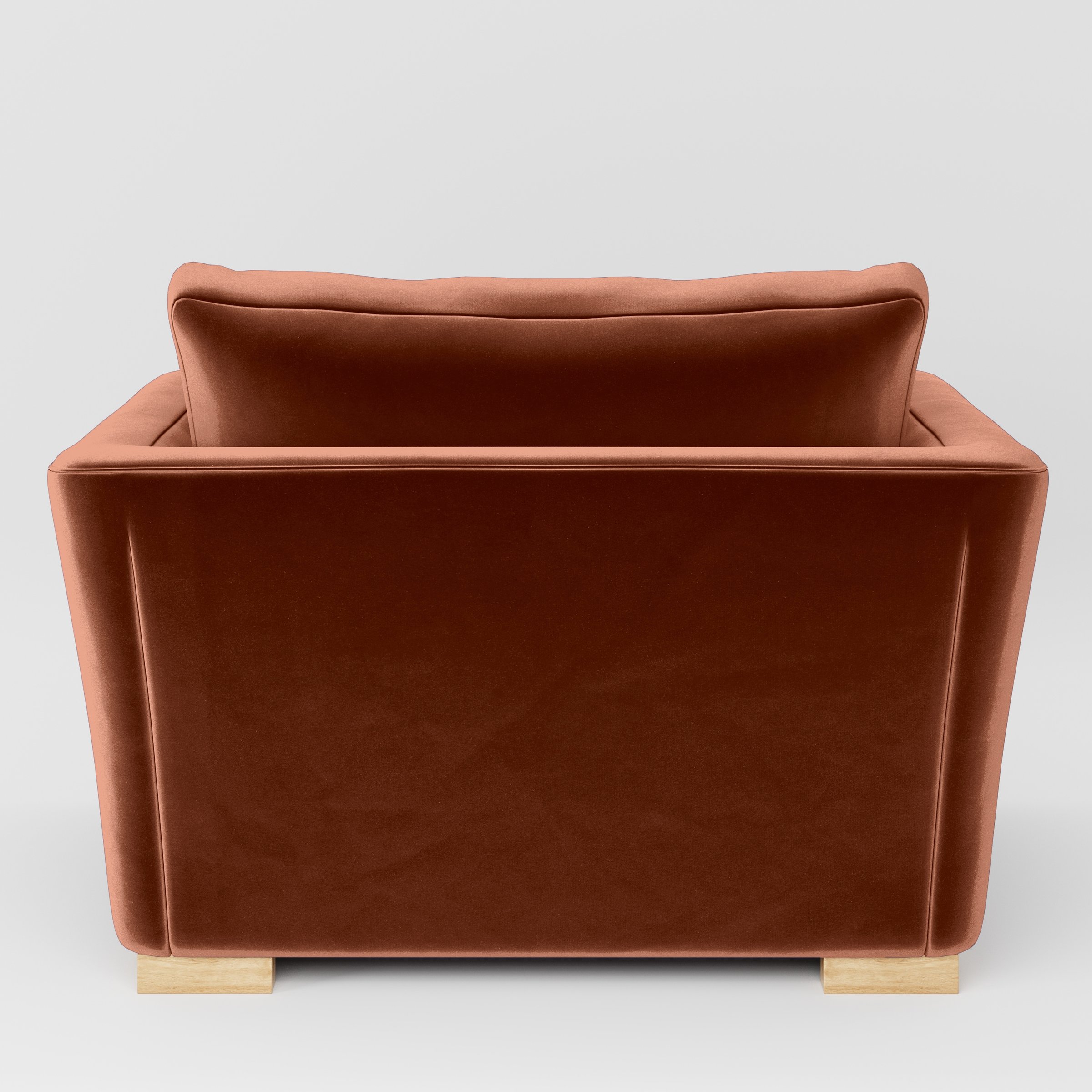Rear view of the Stowe armchair upholstered in Plush EasyClean Velvet in Apricot.