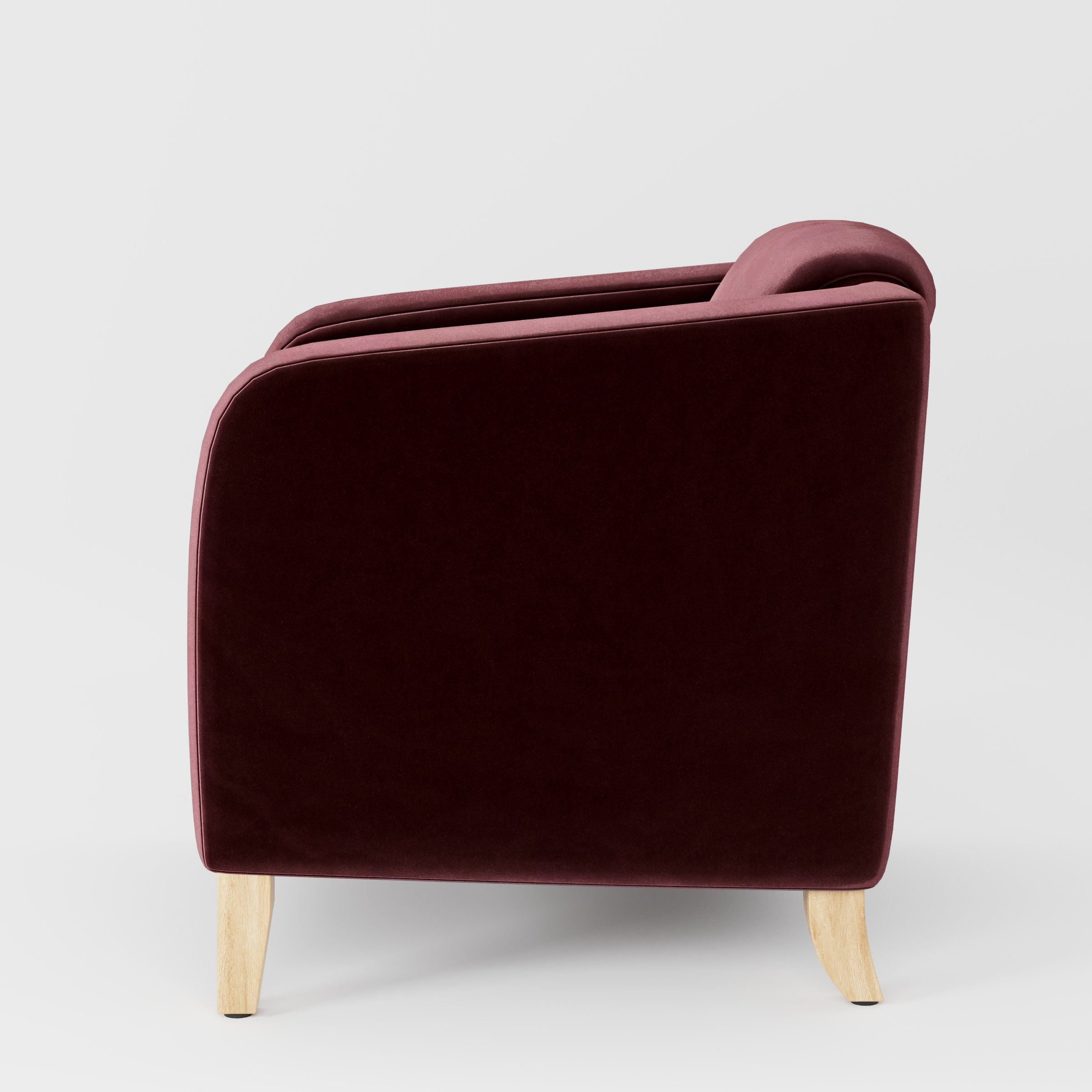 Side view of the Erne armchair upholstered in Plush EasyClean Velvet in Ruby.
