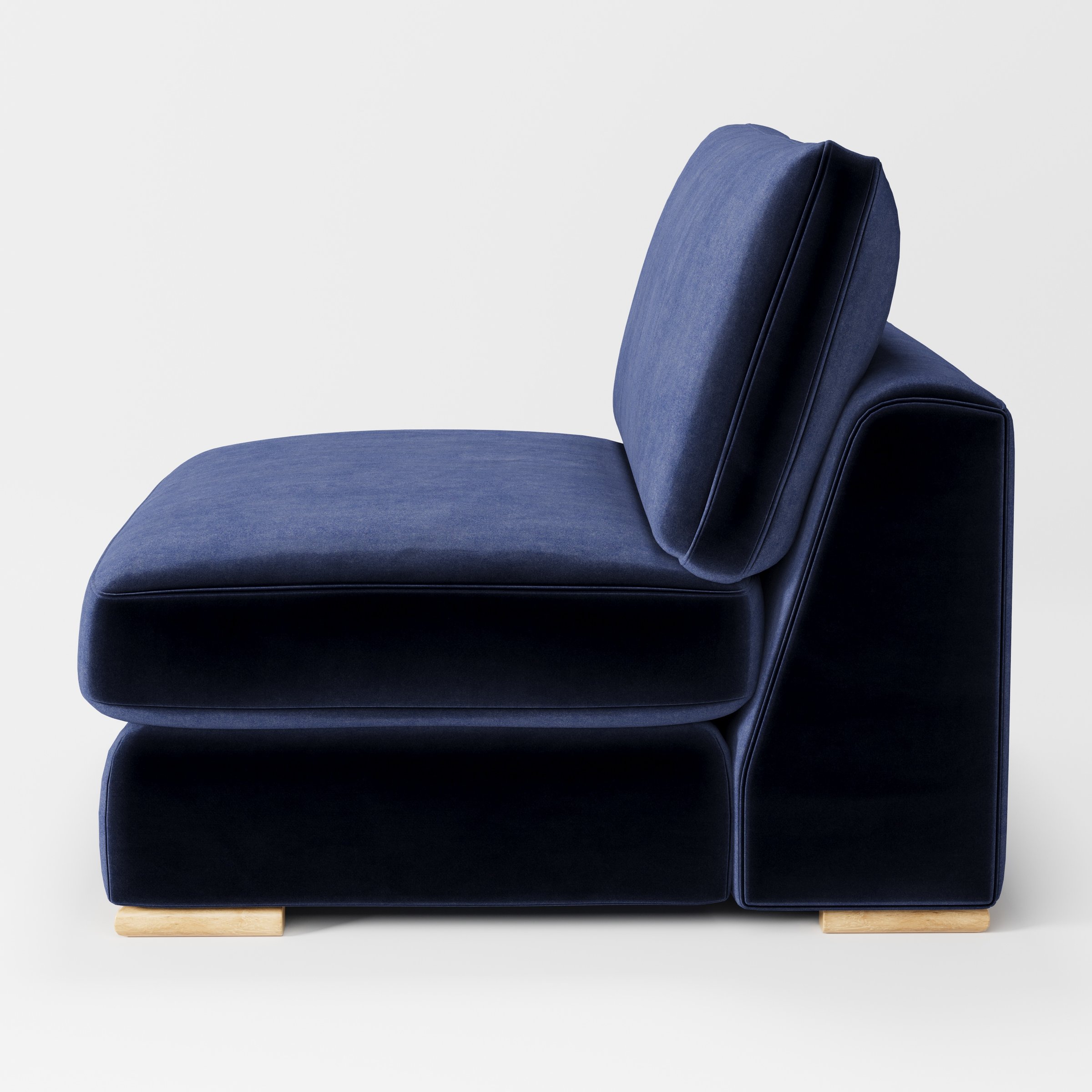 Olton single sofa unit in Noss Velvet Navy shown from the side showing the layered seat cushion and angled back cushion with timber feet.