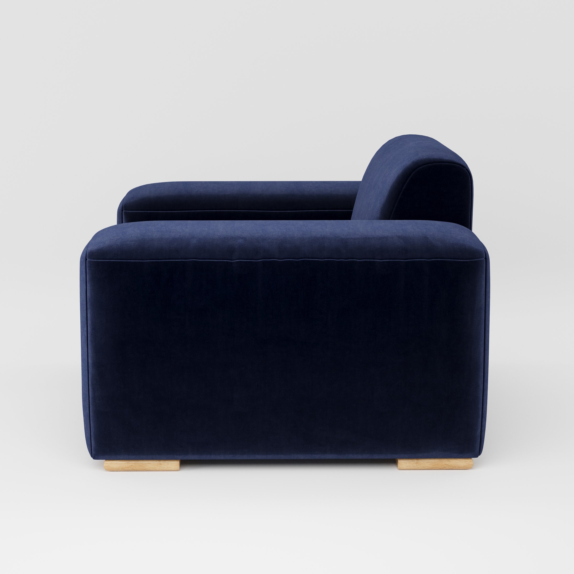 Darwell armchair in Noss Velvet Navy shown in side profile displaying proportions and overall silhouette.