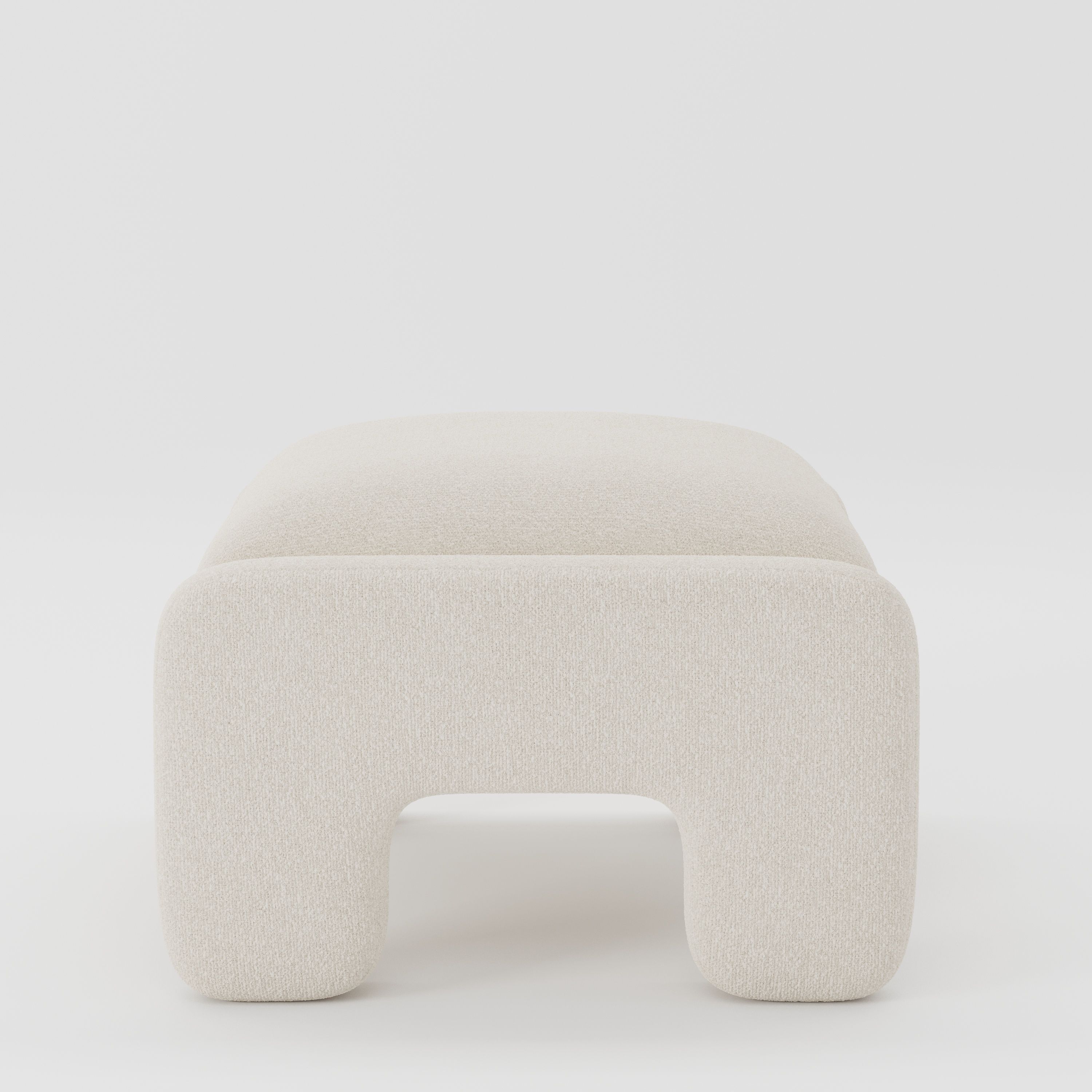Inny footstool in Kilda bouclé cream fabric, side view emphasising minimal profile and continuous upholstery