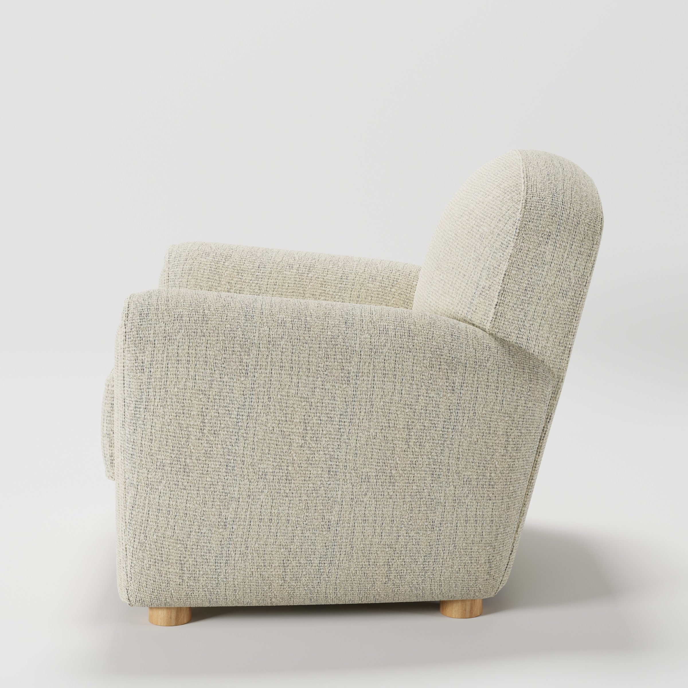 Fergus armchair in Orsay Boucle Cream and Marine shown in side profile displaying proportions and overall silhouette.