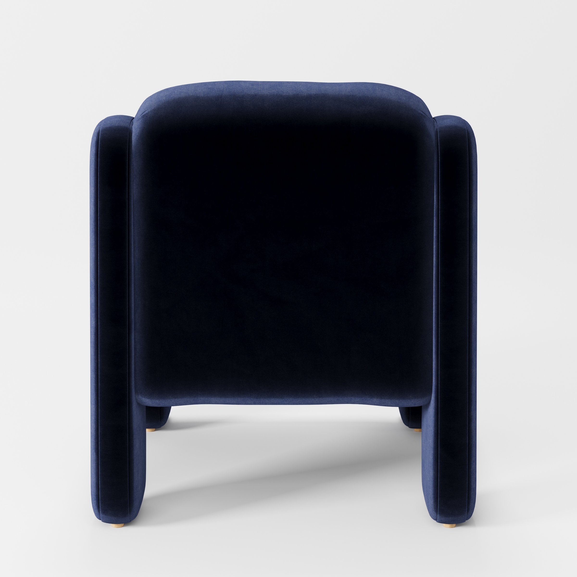 Inny armchair in Noss Velvet Navy shown from the rear highlighting curved backrest and upholstery finish.