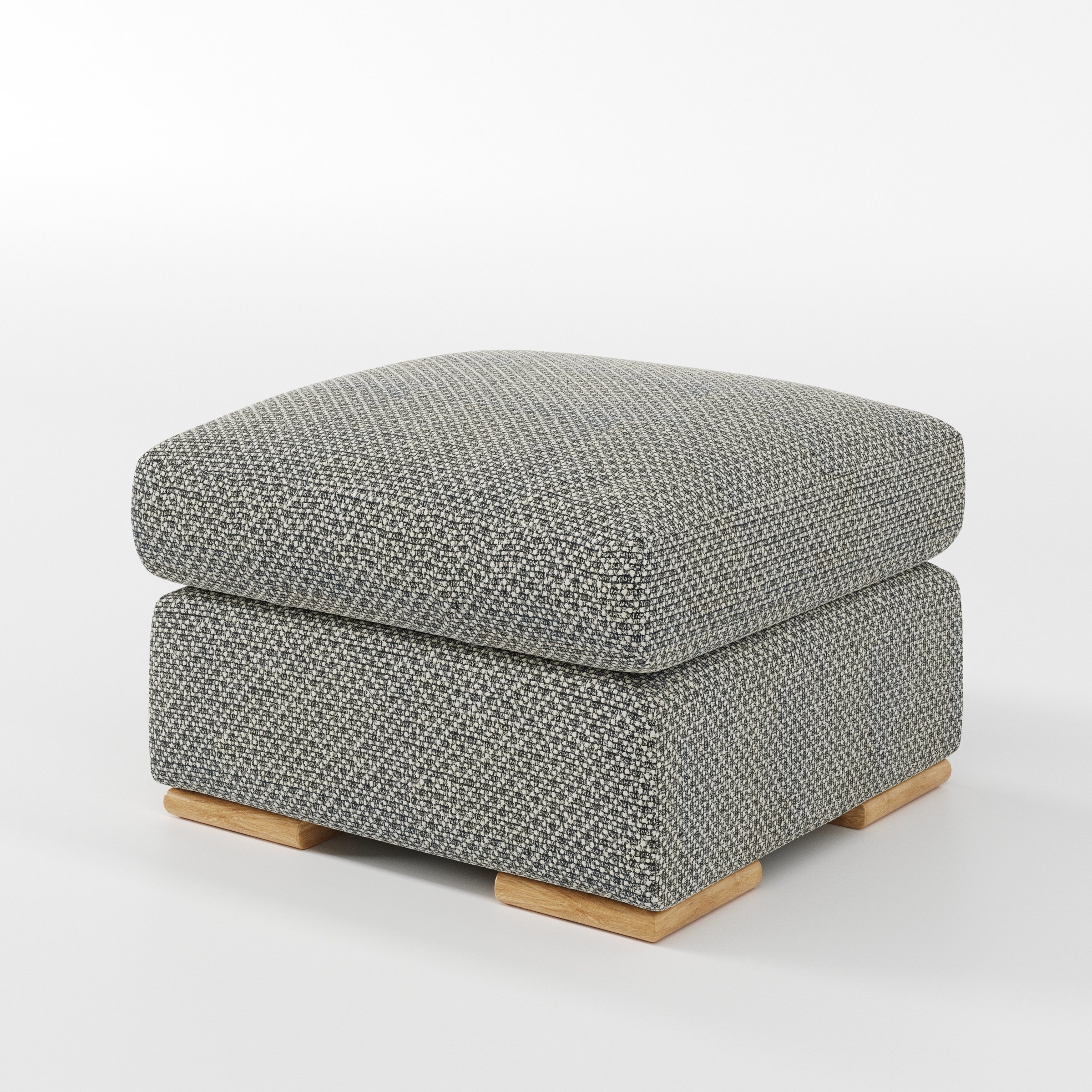 Moy footstool in Rousay Wool Blend Tar and Chalk shown at a diagonal angle highlighting deep cushioning and low wooden base.