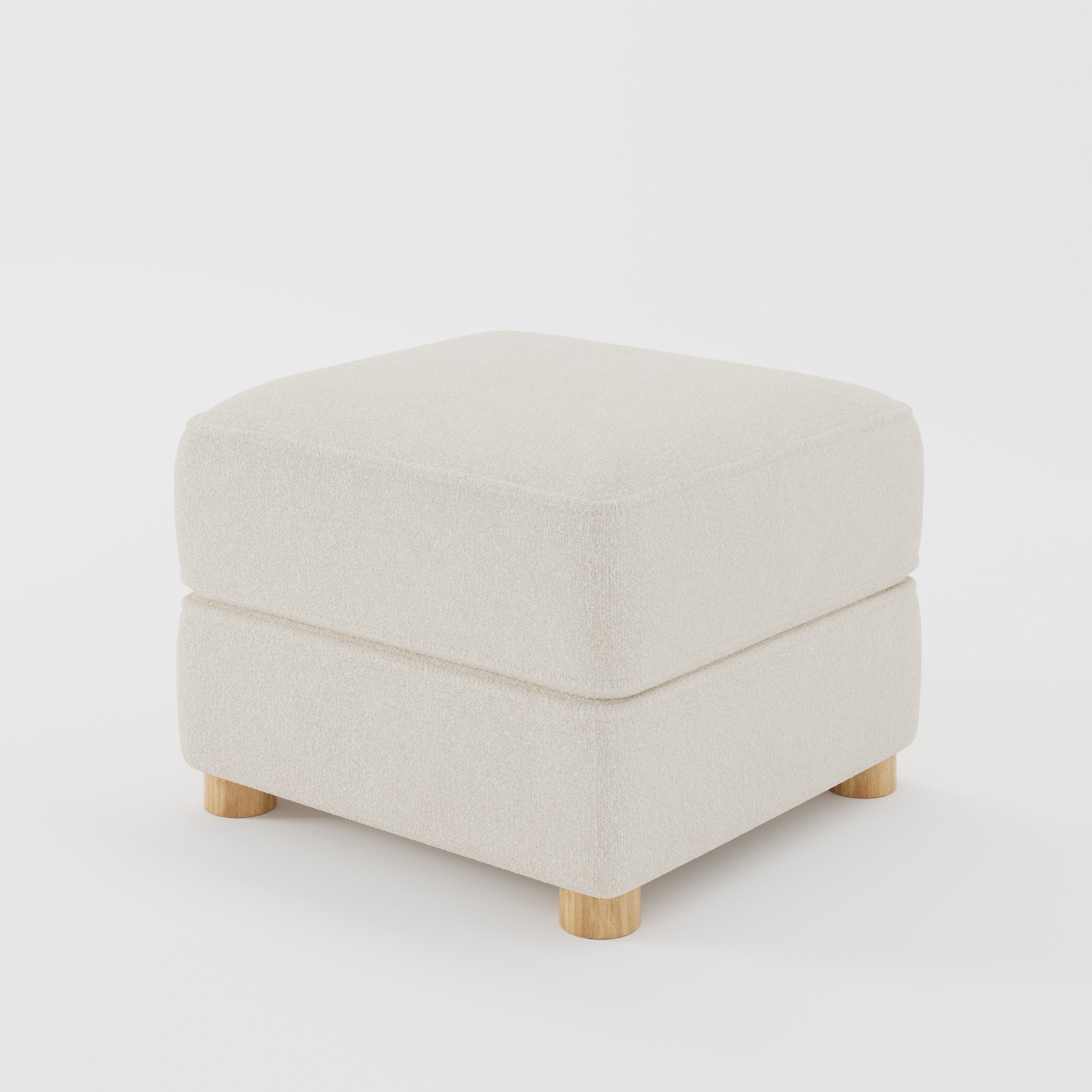 Fergus footstool in Kilda Boucle Cream shown at a diagonal angle highlighting compact proportions and rounded wooden feet.