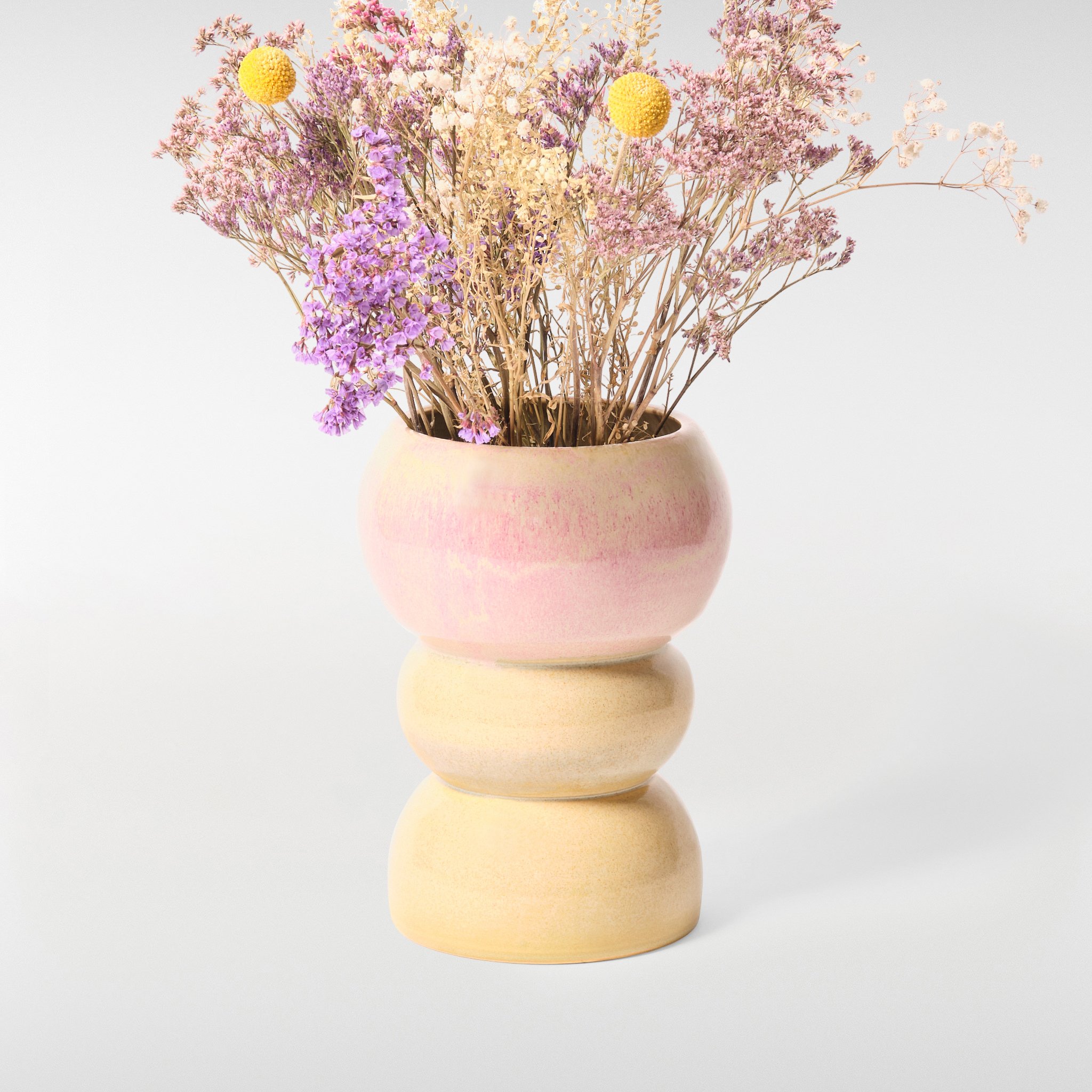 Loam Vase 1 in pink and cream glaze with dried flowers, rounded stacked ceramic vase