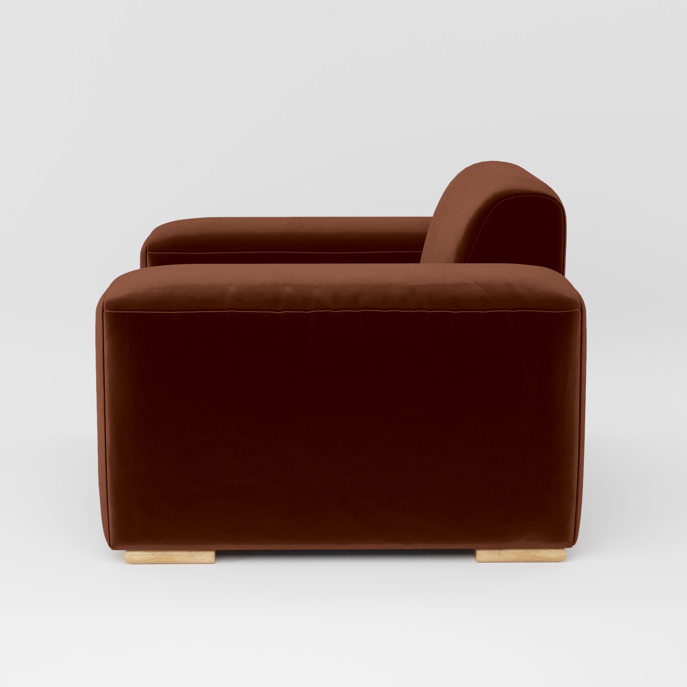 Side view of the Darwell armchair upholstered in Plush EasyClean Velvet in Maple.