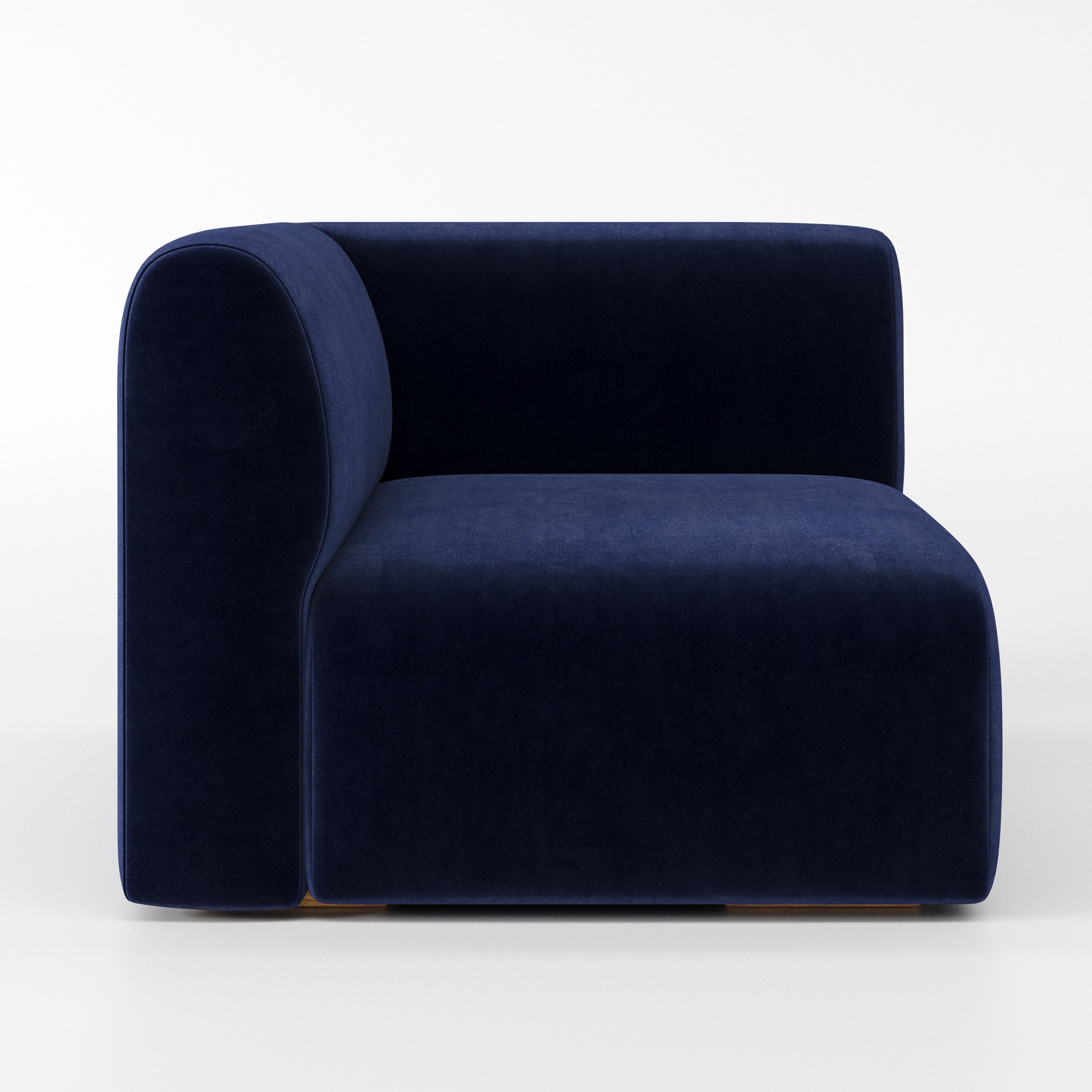 Drumquin modular sofa corner unit in Noss Velvet Navy shown from the left highlighting the wraparound back and soft, sculpted form.