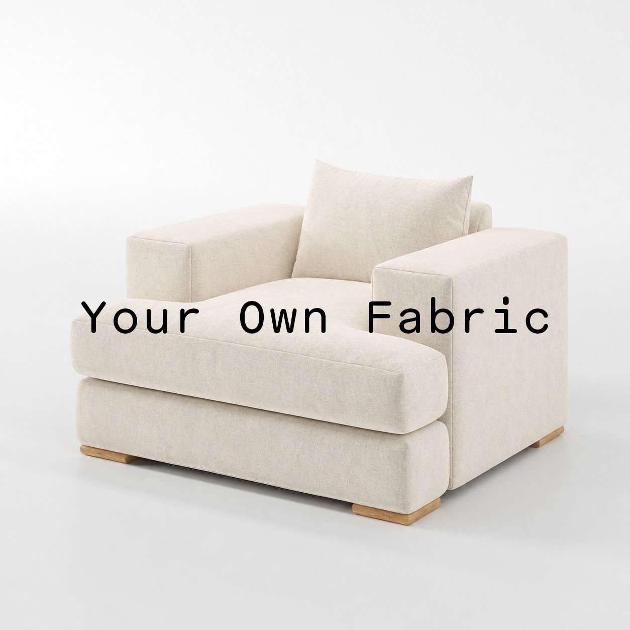 Diagonal view of the Fane armchair upholstered in customers own material calico cotton fabric.