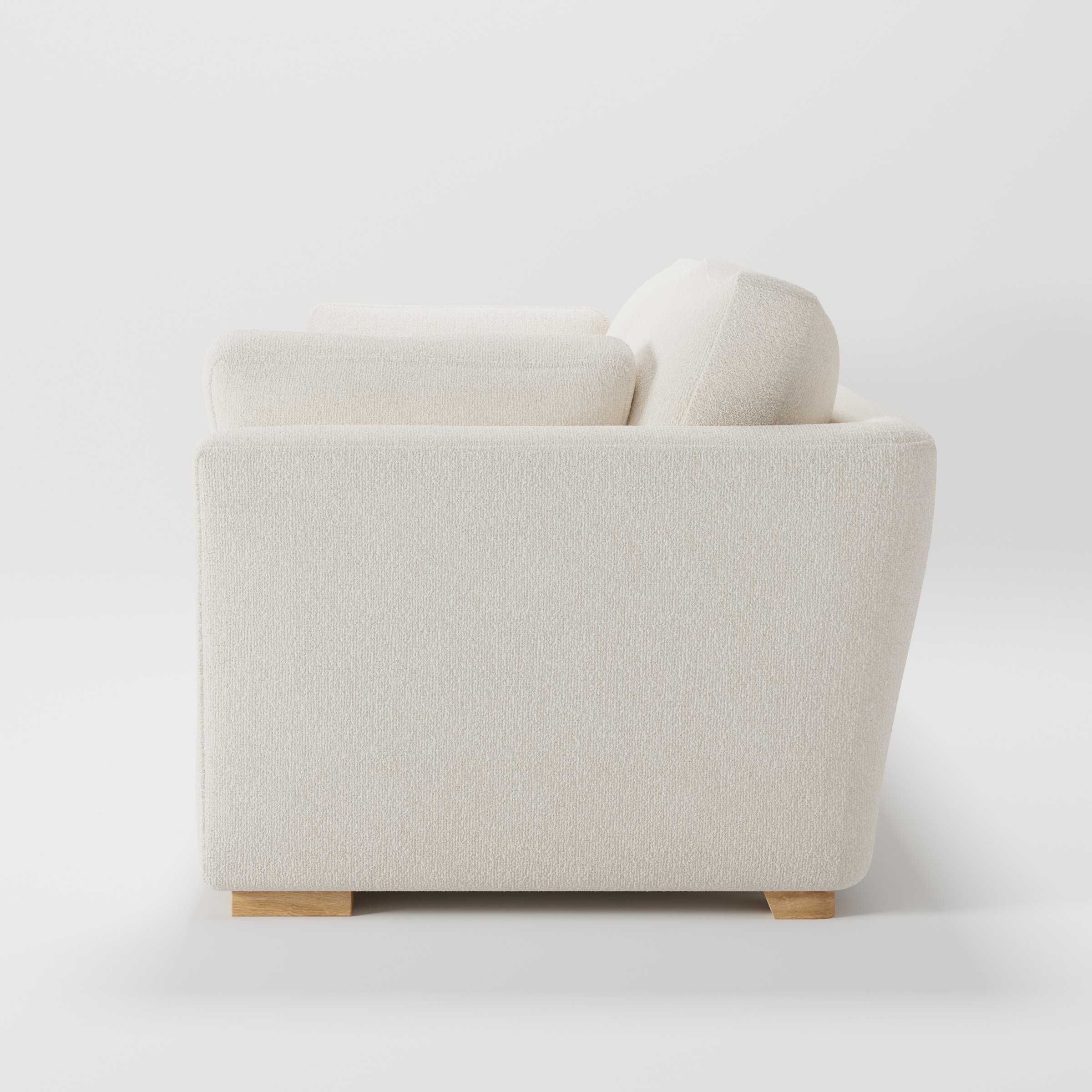 Stowe sofa in Kilda Boucle Cream shown in side profile displaying proportions and overall silhouette.