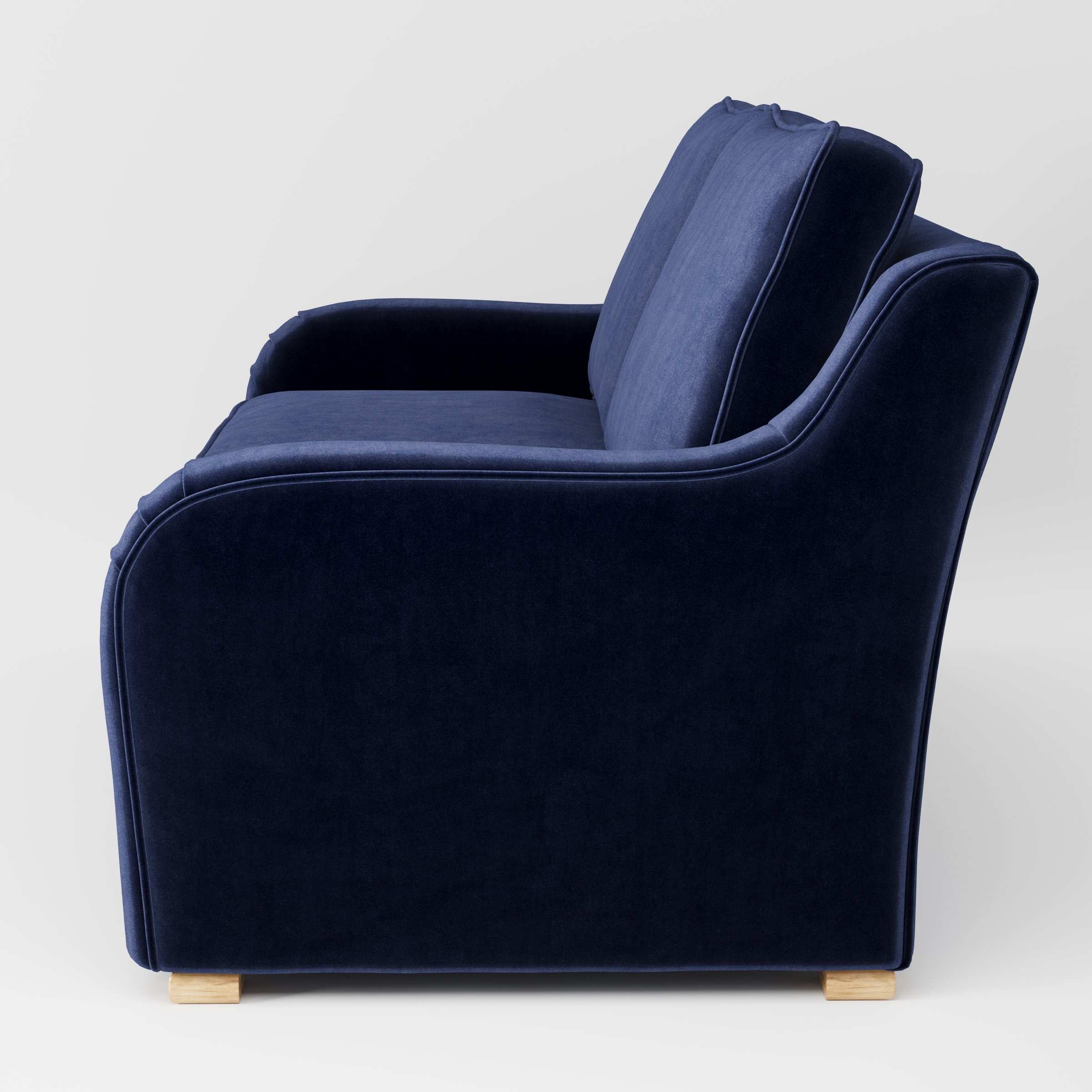 Cashel sofa in Noss Velvet Navy shown in side profile displaying proportions and overall silhouette.