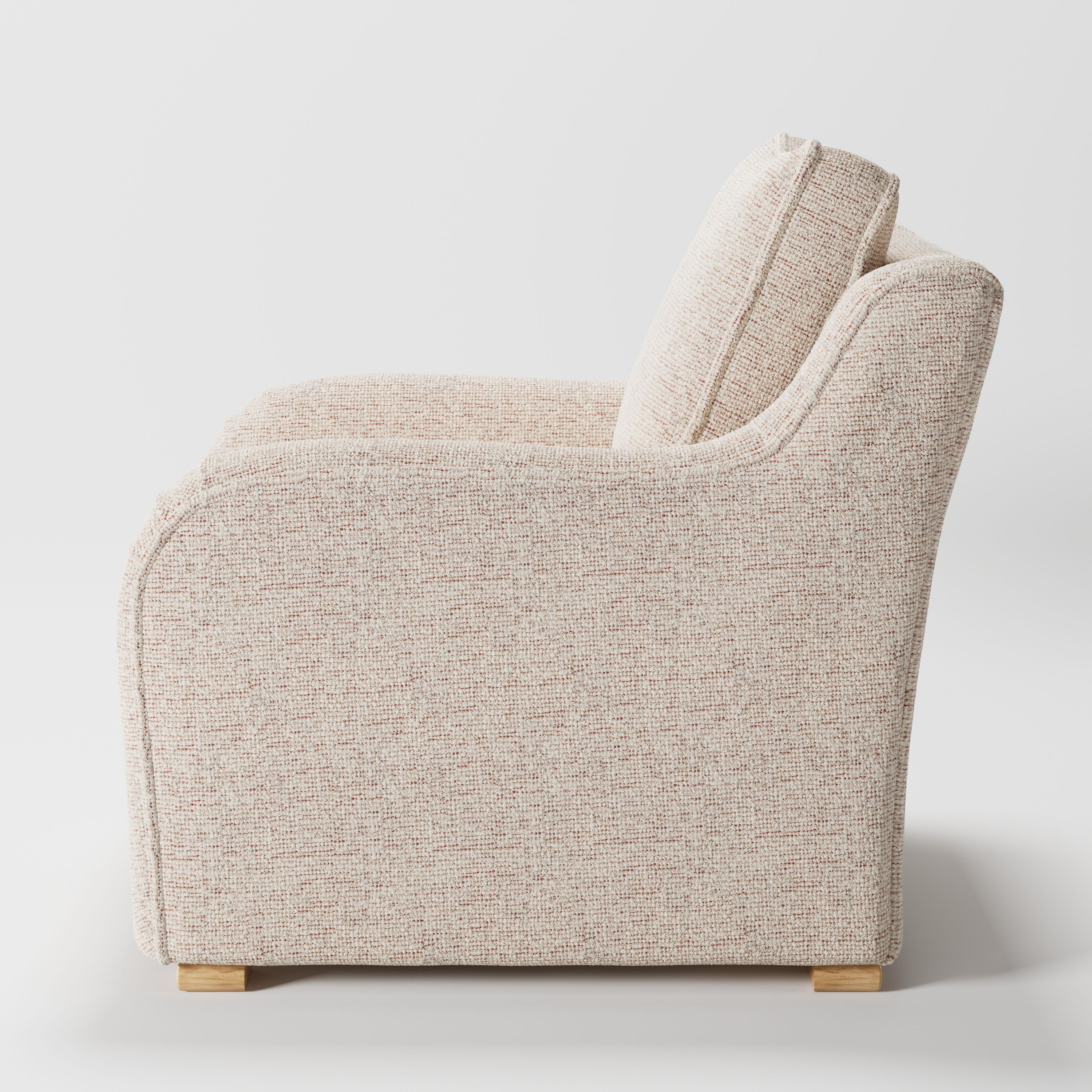 Cashel armchair in Orsay Boucle Cream and Copper shown in side profile displaying proportions and overall silhouette.