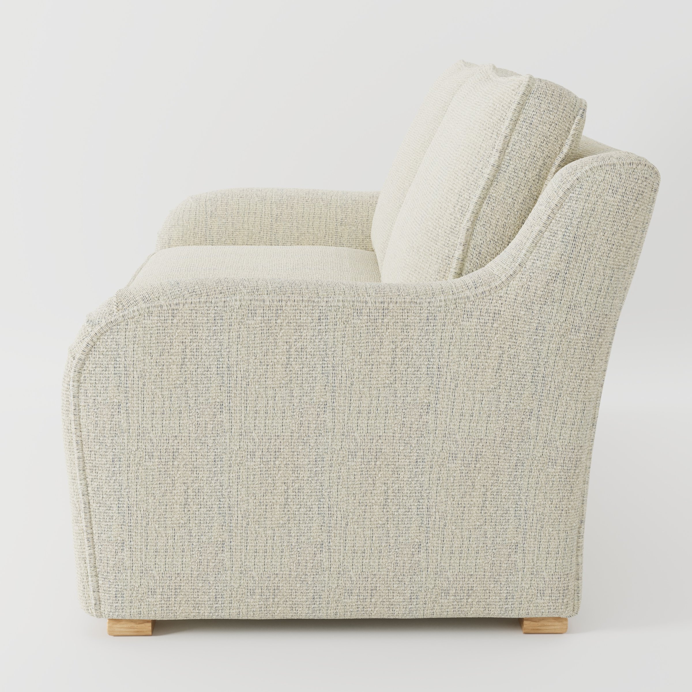 Cashel sofa in Orsay Boucle Cream and Marine shown in side profile displaying proportions and overall silhouette.