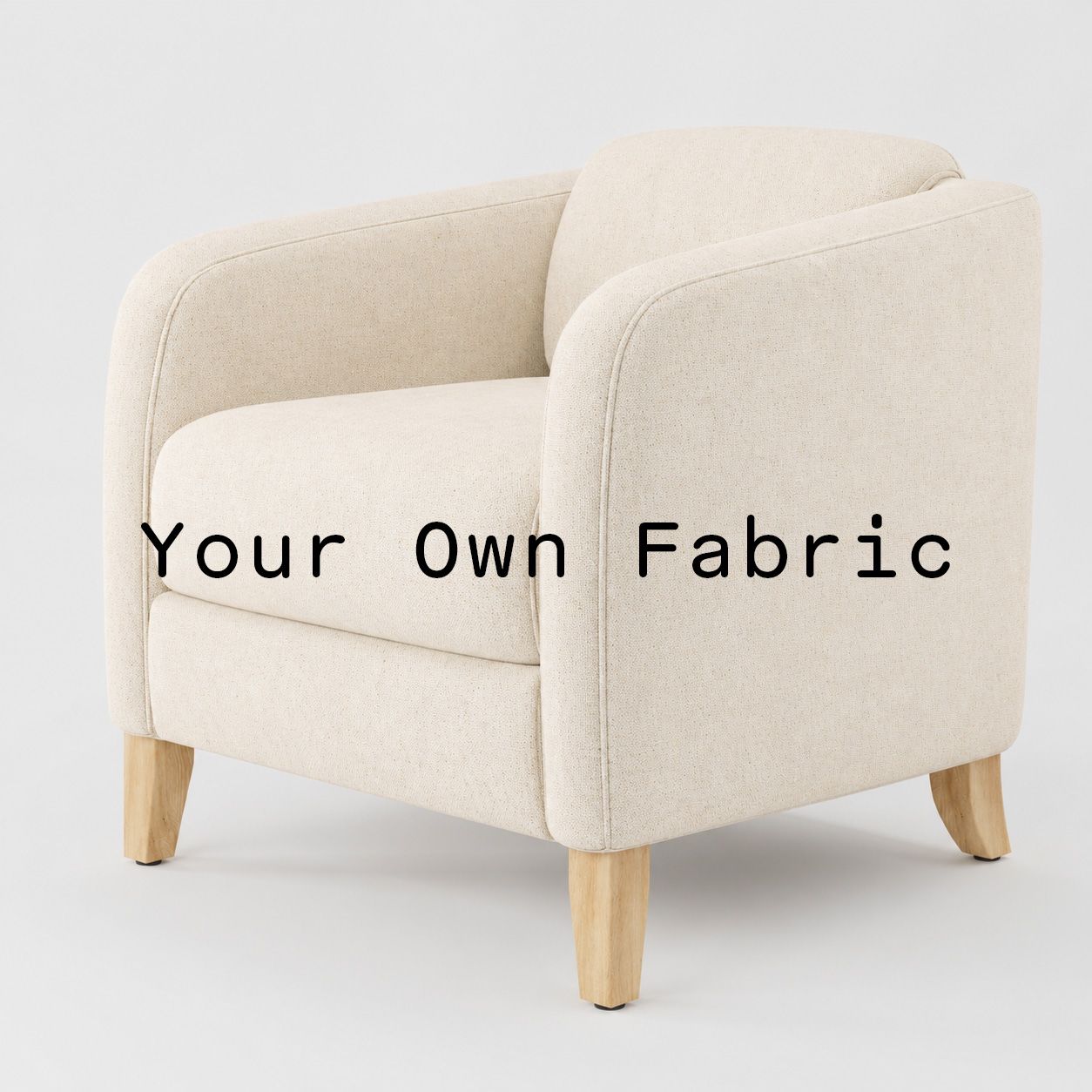 Diagonal view of the Erne armchair upholstered in customers own material calico cotton fabric.