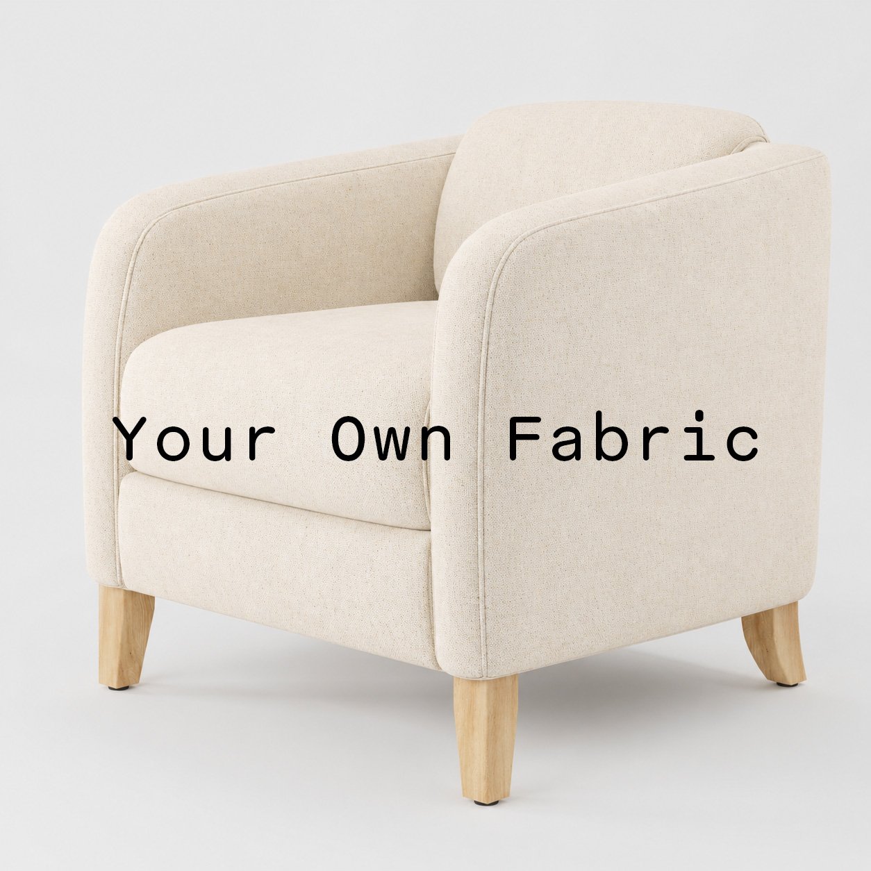 Diagonal view of the Erne armchair upholstered in customers own material calico cotton fabric.