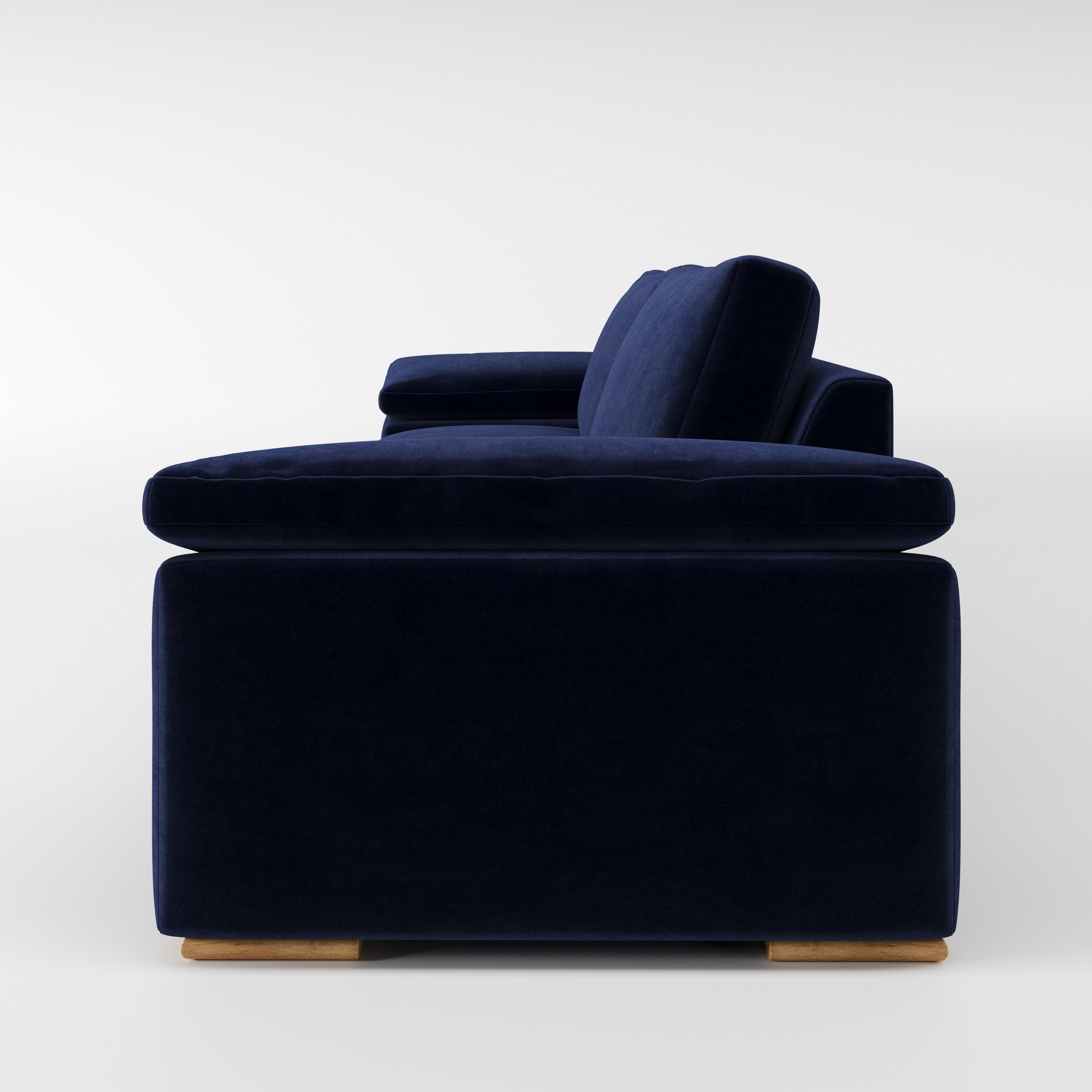 Moy sofa in Noss Velvet Navy shown in side profile displaying proportions and overall silhouette.