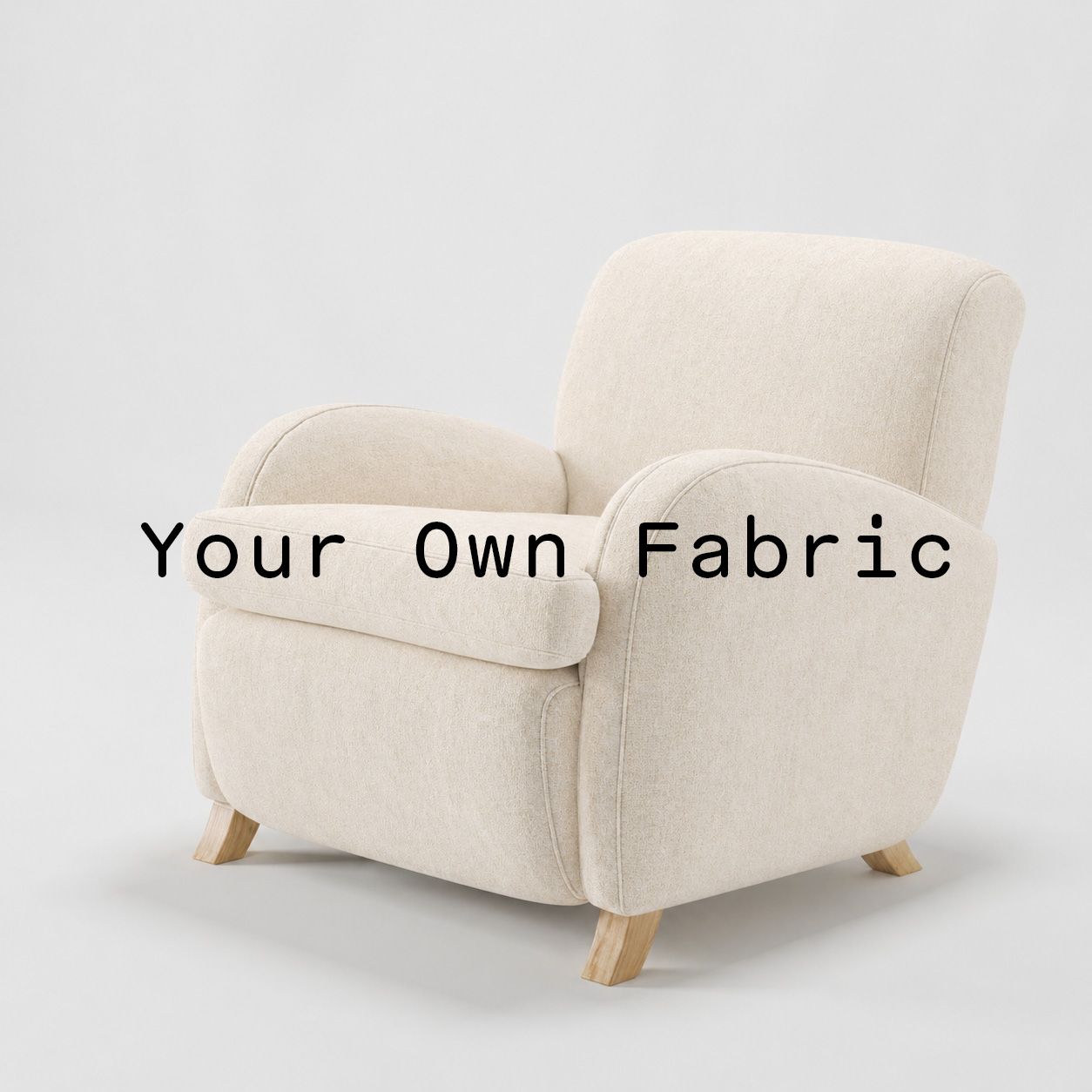 Diagonal view of the Rye armchair upholstered in customers own material calico cotton fabric.