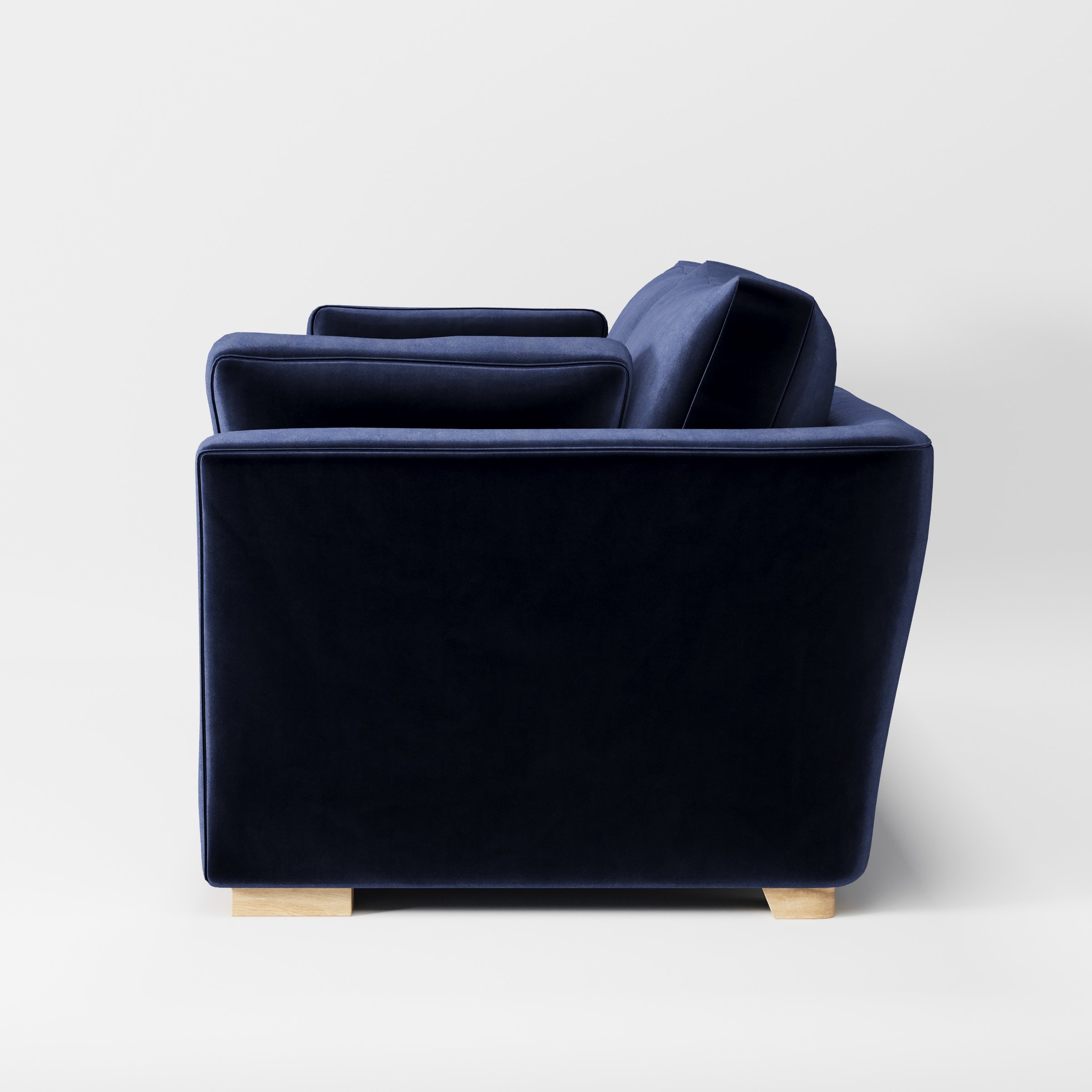 Stowe sofa in Noss Velvet Navy shown in side profile displaying proportions and overall silhouette.