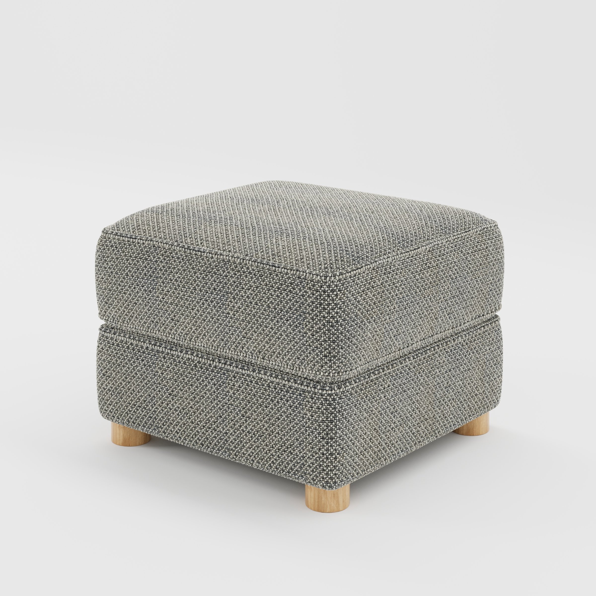 Fergus footstool in Rousay Wool Blend Tar and Chalk shown at a diagonal angle highlighting compact proportions and rounded wooden feet.
