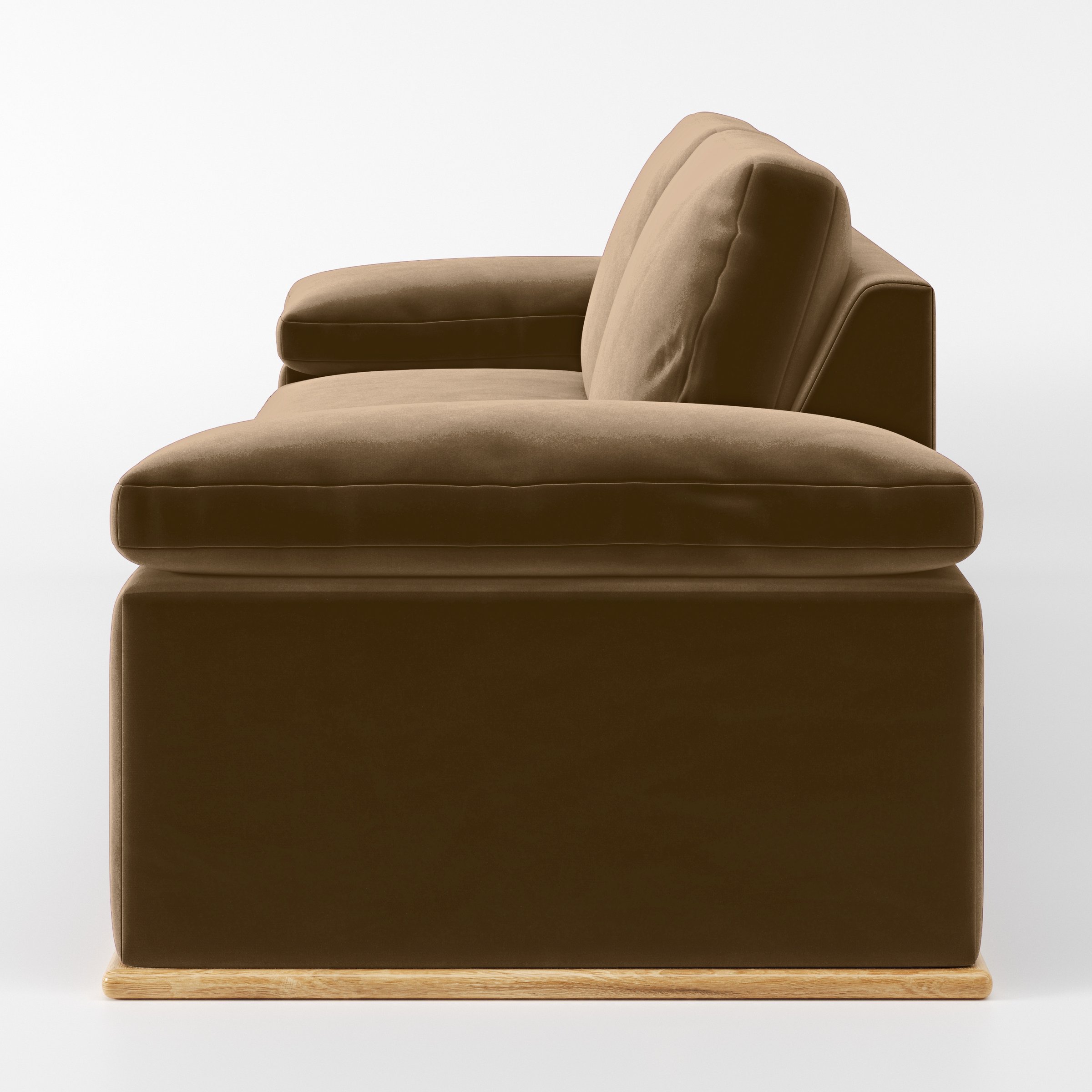 Side view of the Cusher sofa upholstered in Plush EasyClean Velvet in Caribou.