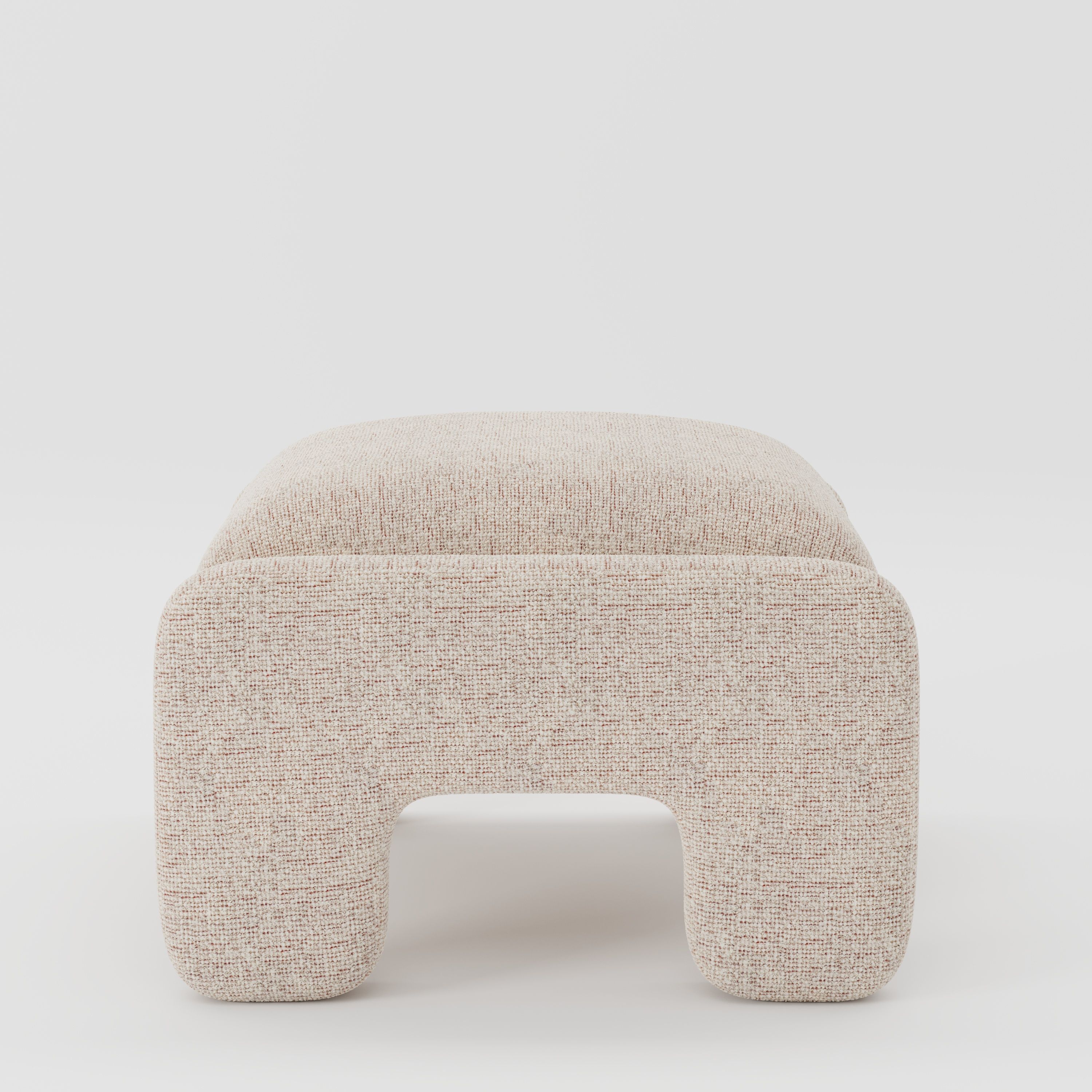 Inny footstool in Orsay bouclé cream and copper fabric, side view emphasising low profile and sculptural shape