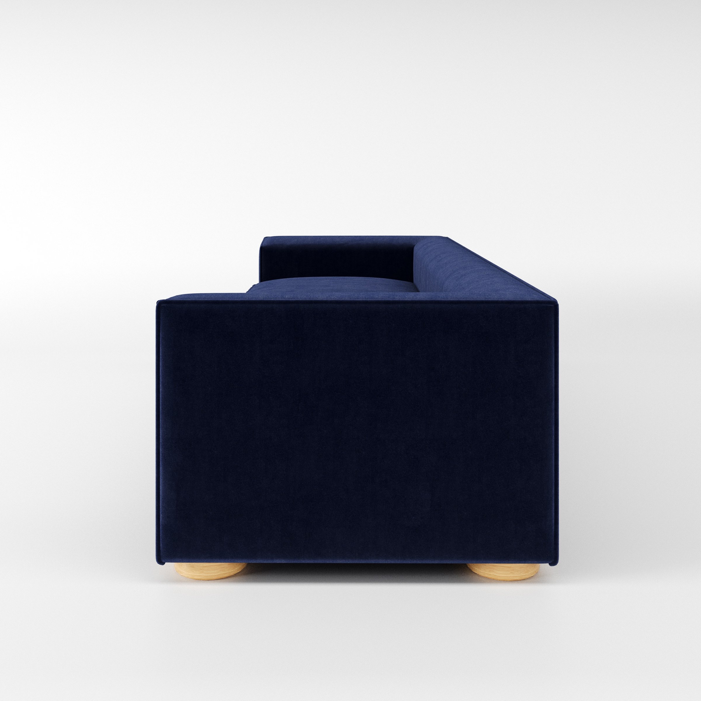 Feale sofa in Noss Velvet Navy shown in side profile displaying proportions and overall silhouette.