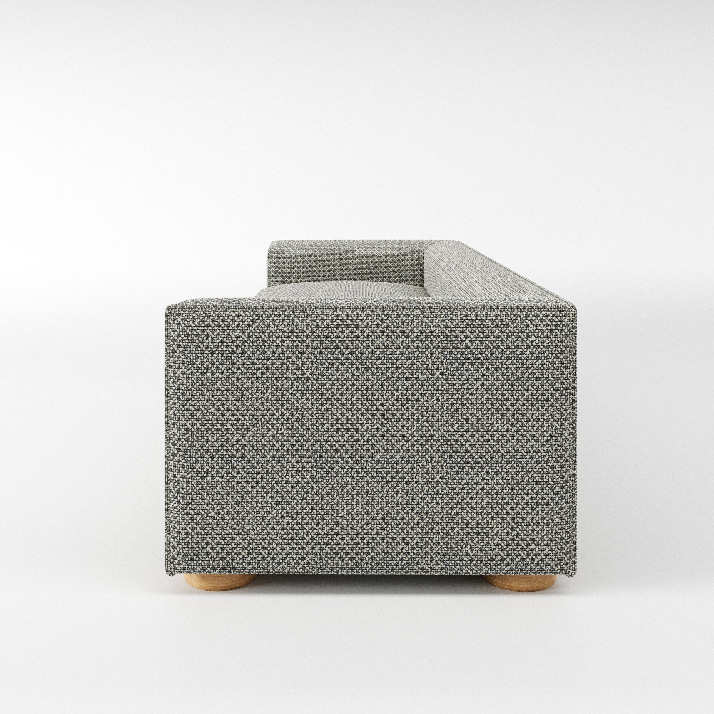 Feale sofa in Rousay Wool Blend Tar and Chalk shown in side profile displaying proportions and overall silhouette.
