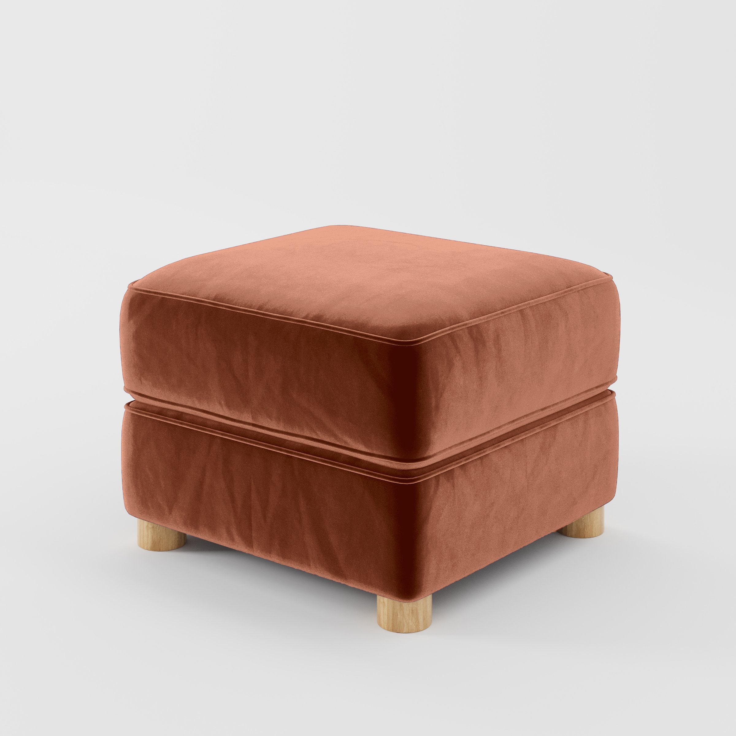 Diagonal view of the Fergus footstool upholstered in Plush EasyClean Velvet in Apricot.