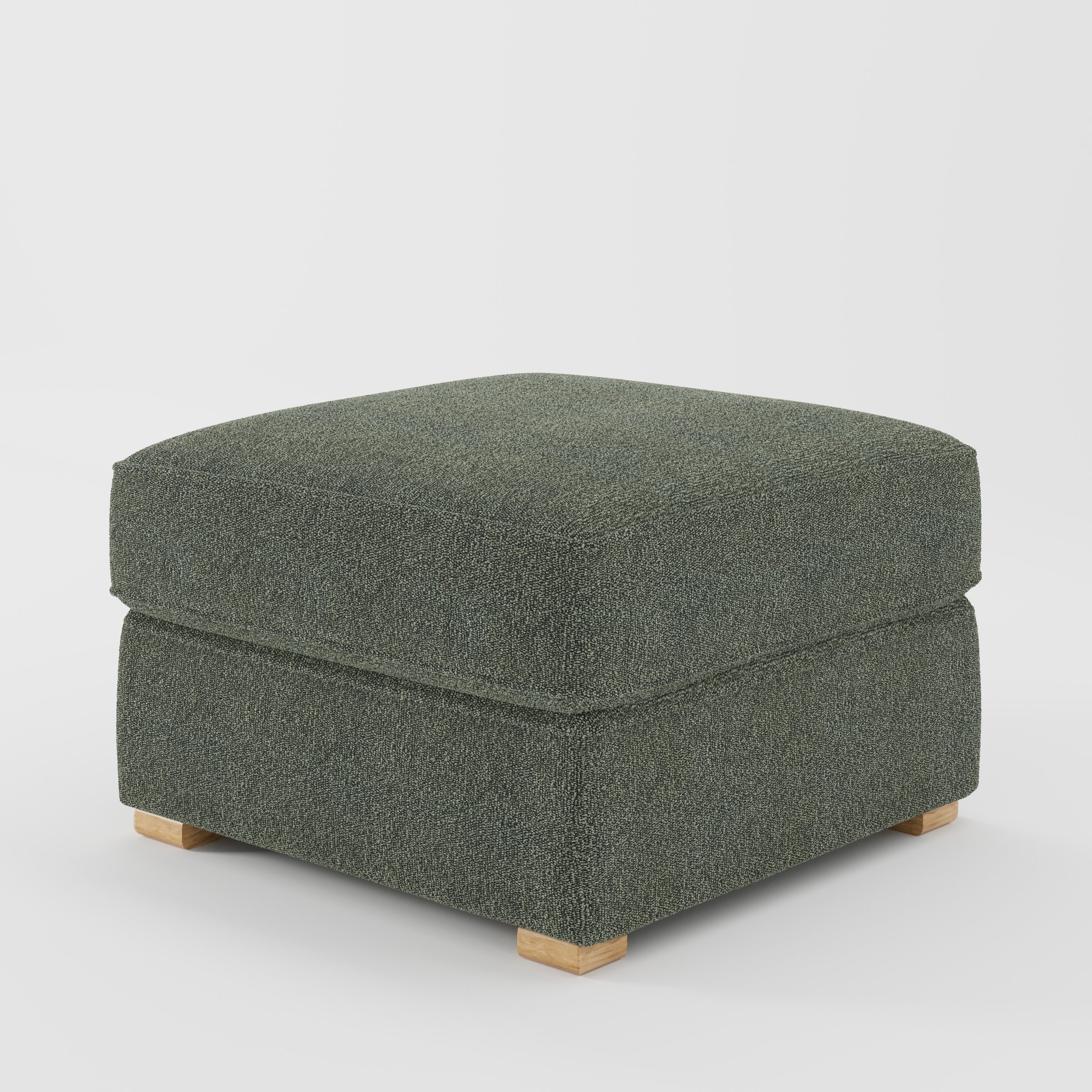 Cashel footstool in Kilda Boucle Moss shown at a diagonal angle highlighting layered cushioning and low wooden feet.