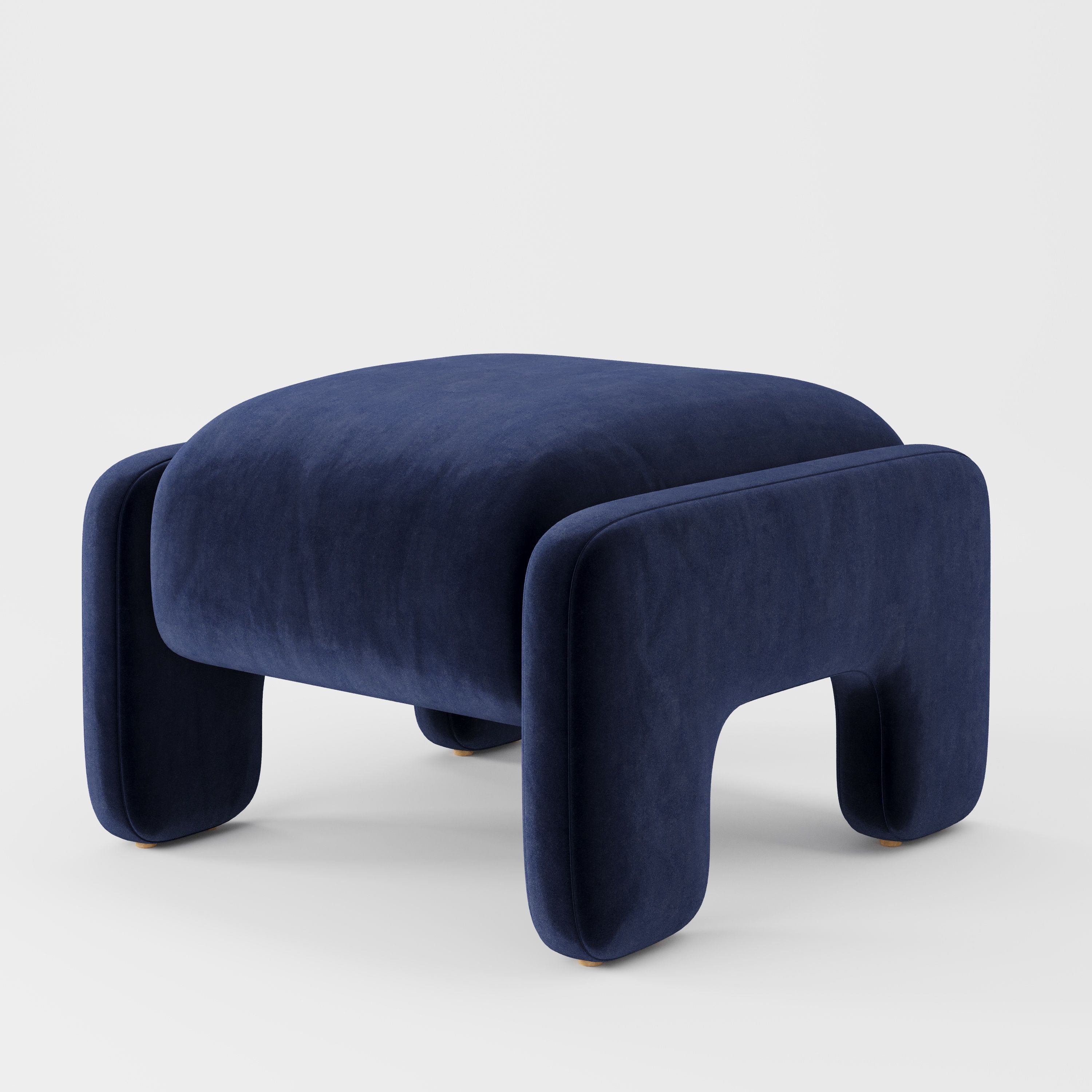 Inny footstool in Noss velvet navy fabric, diagonal view highlighting soft curves and subtle sheen