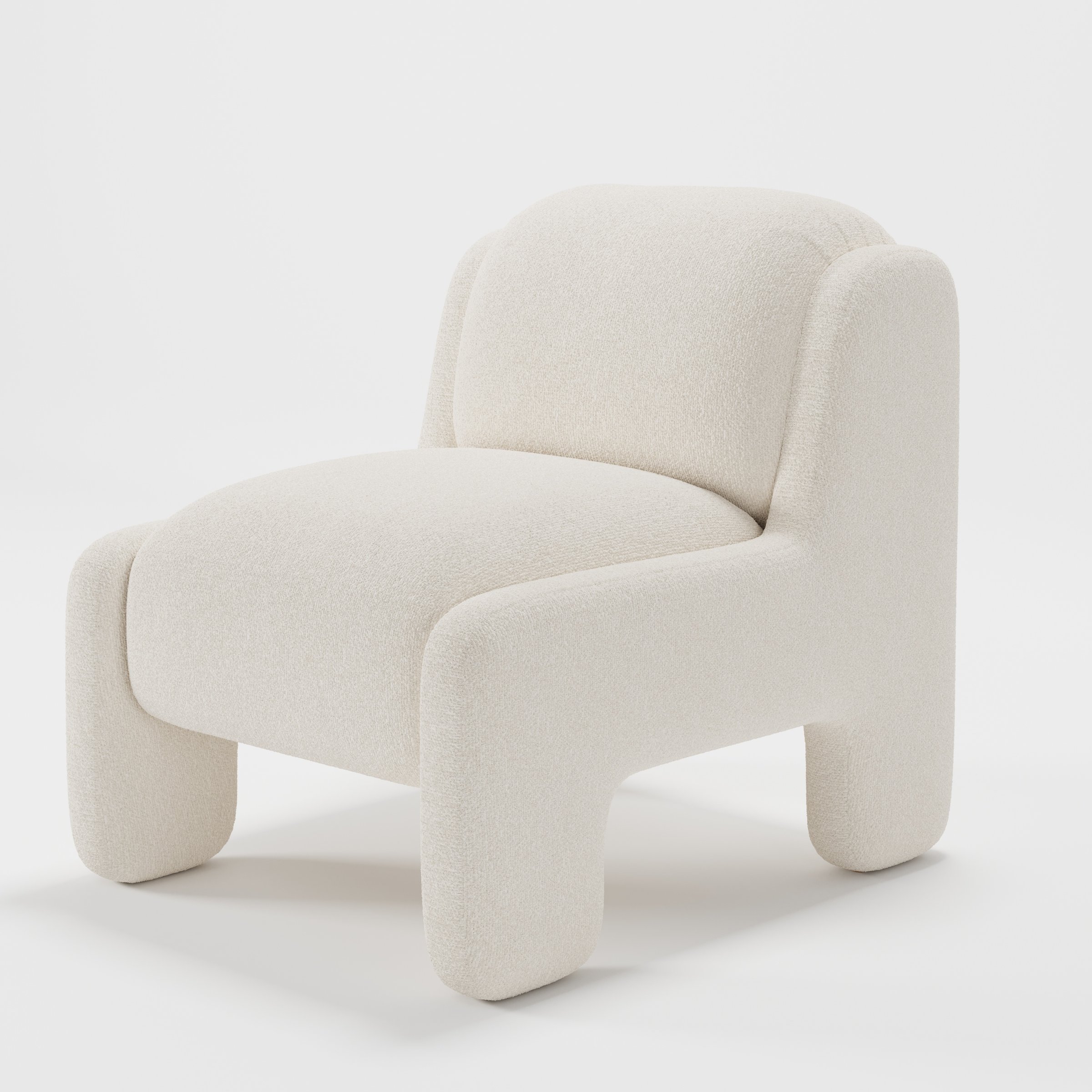 Inny armchair in Kilda Boucle Cream shown at a diagonal angle highlighting sculpted form and low seat.