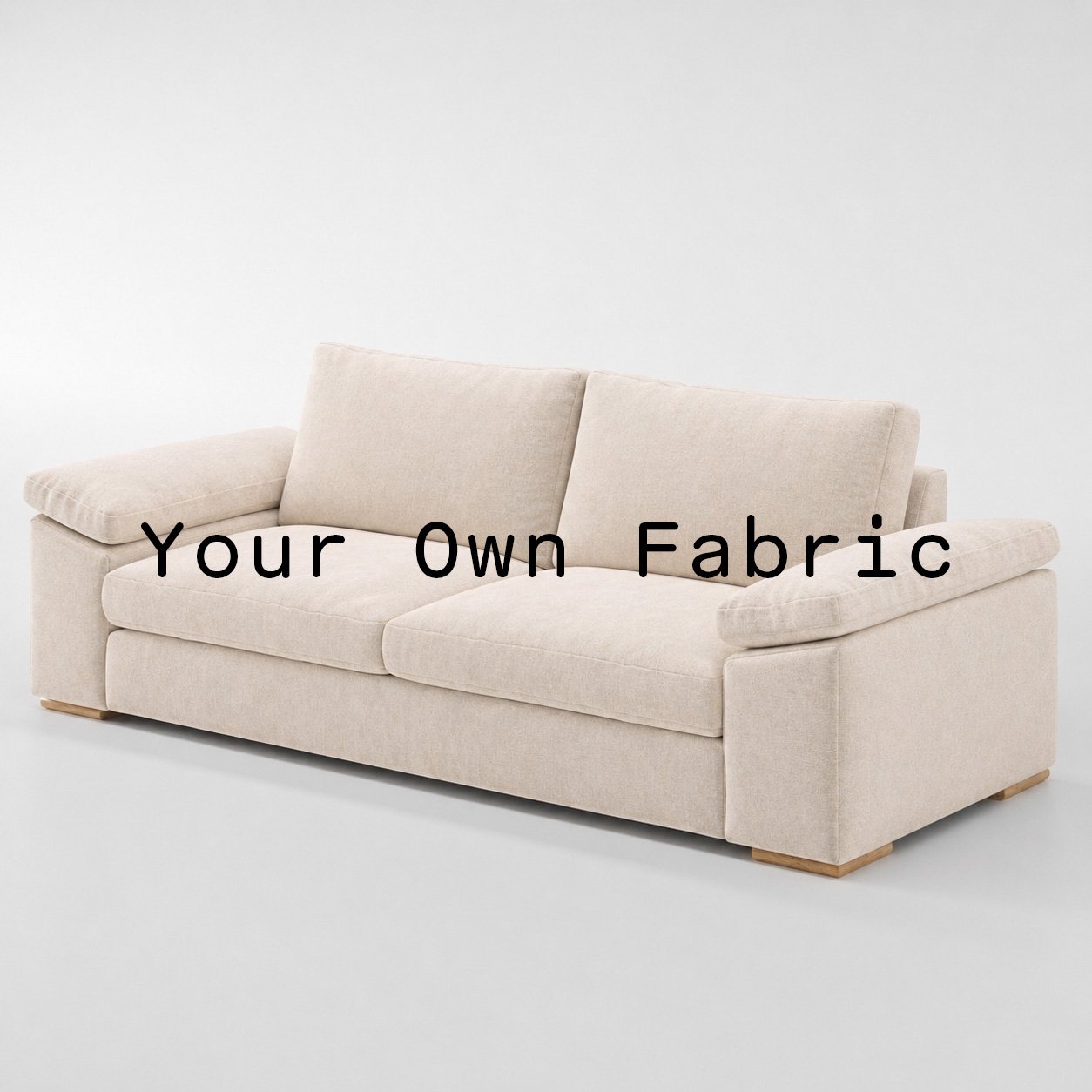 Diagonal view of the Moy sofa upholstered in customers own material calico cotton fabric.