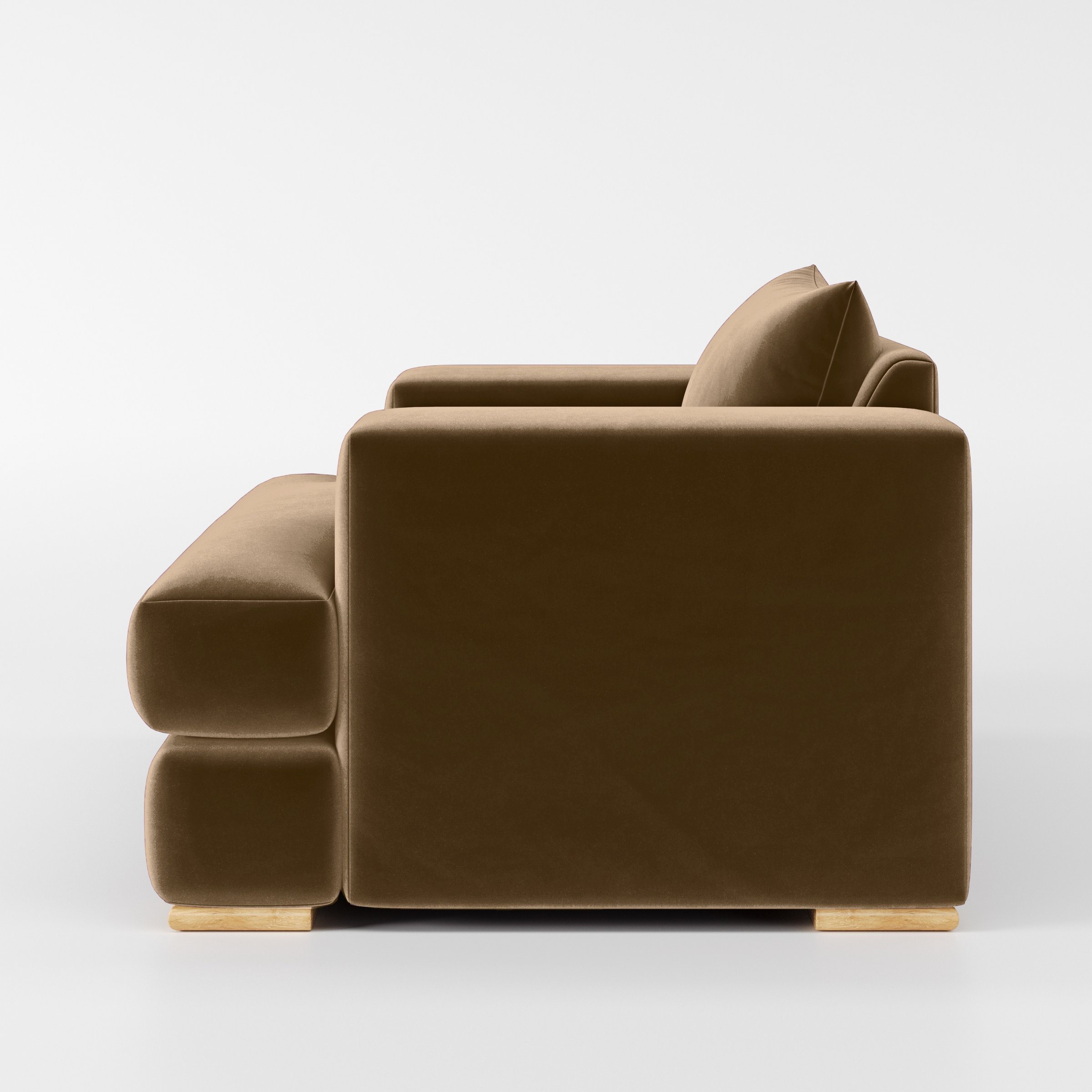 Side view of the Fane armchair upholstered in Plush EasyClean Velvet in Caribou.