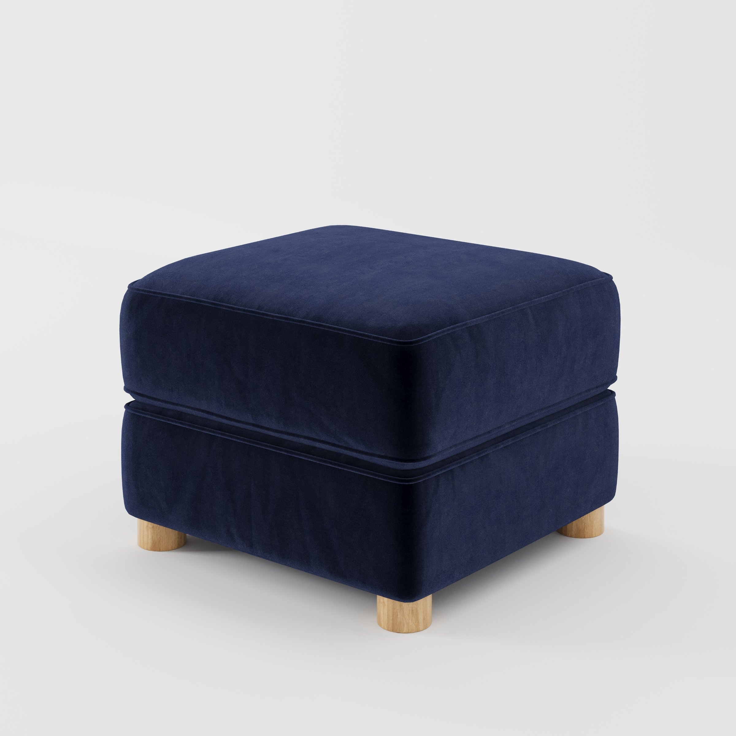 Fergus footstool in Noss Velvet Navy shown at a diagonal angle highlighting compact proportions and rounded wooden feet.