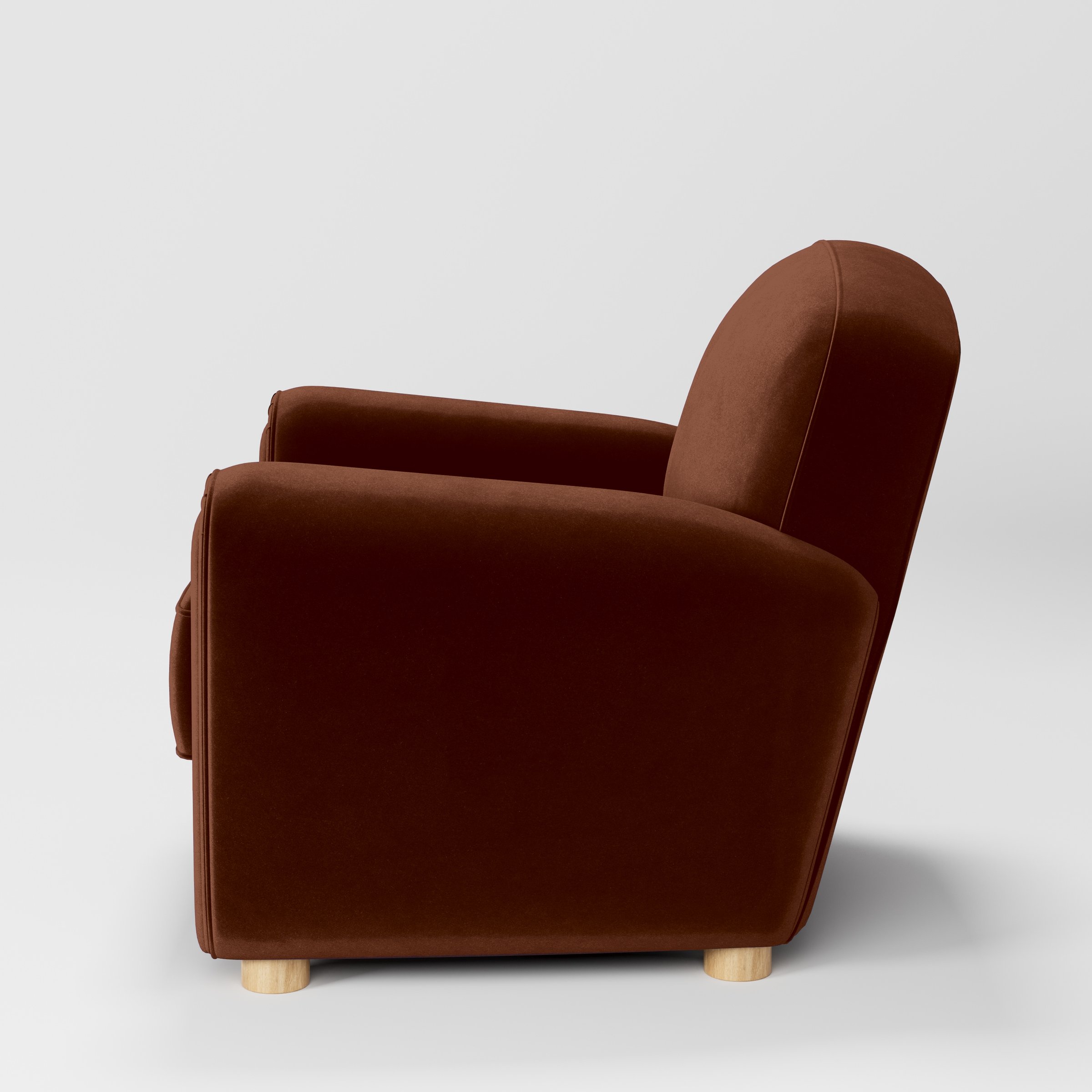 Side view of the Fergus armchair upholstered in Plush EasyClean Velvet in Maple.