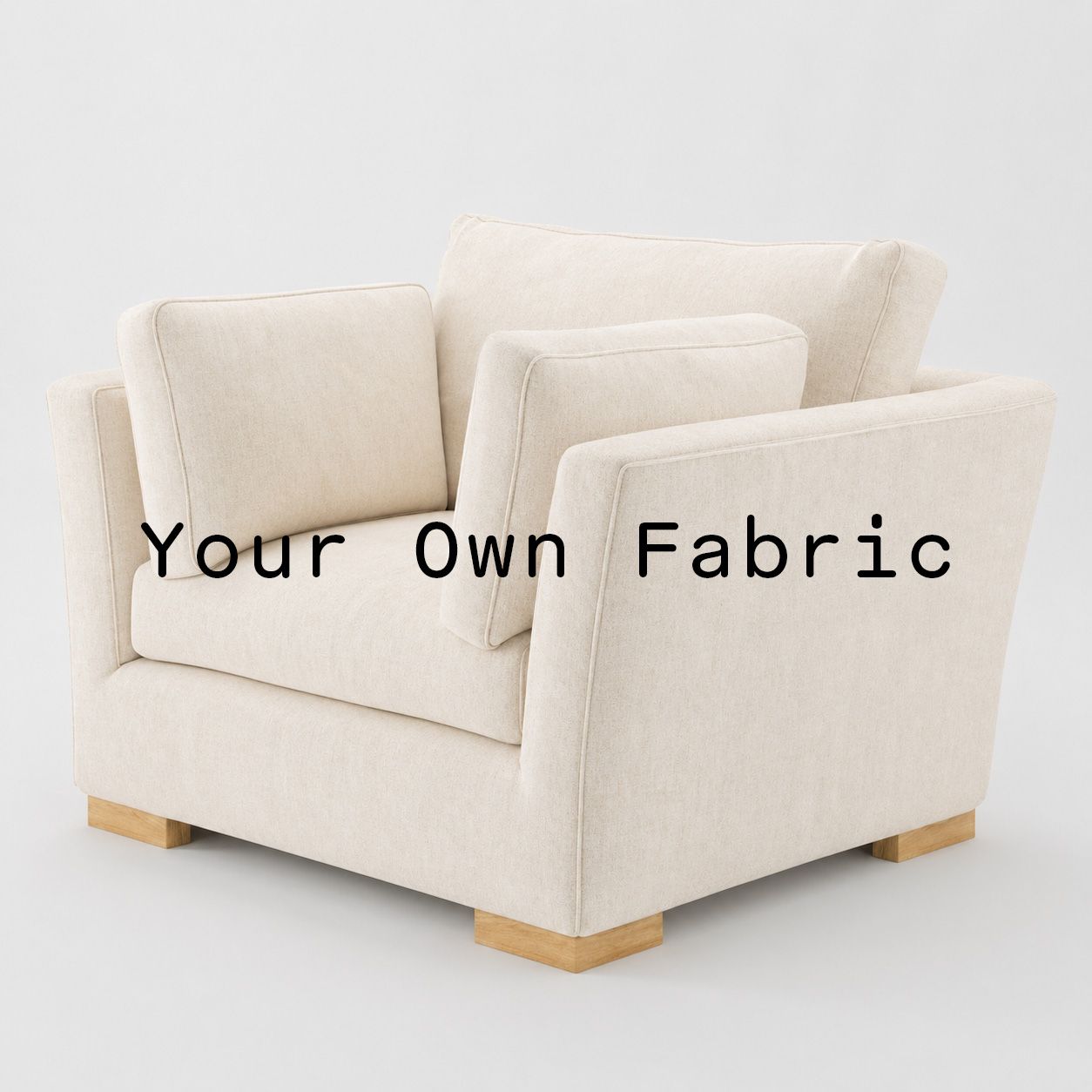 Diagonal view of the Stowe armchair upholstered in customers own material calico cotton fabric.