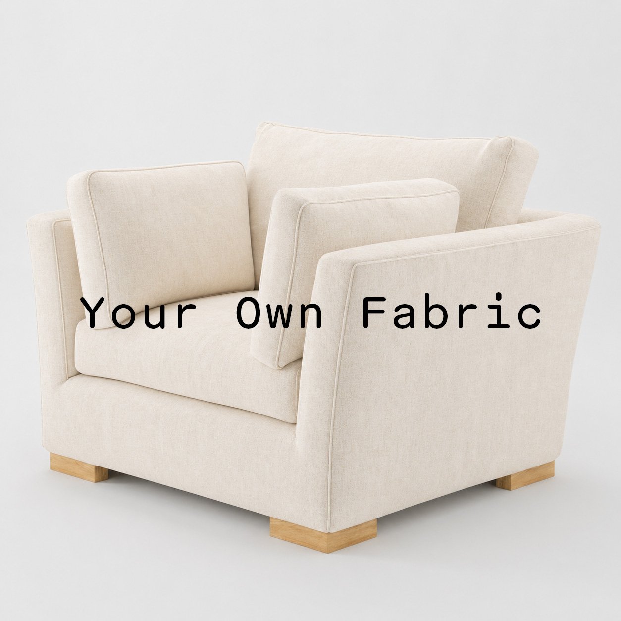 Diagonal view of the Stowe armchair upholstered in customers own material calico cotton fabric.