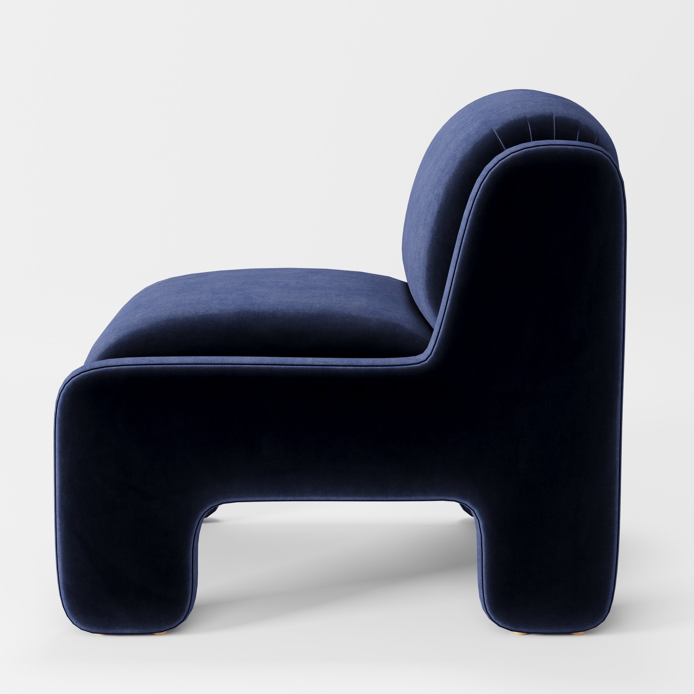Inny armchair in Noss Velvet Navy shown in side profile displaying proportions and overall silhouette.