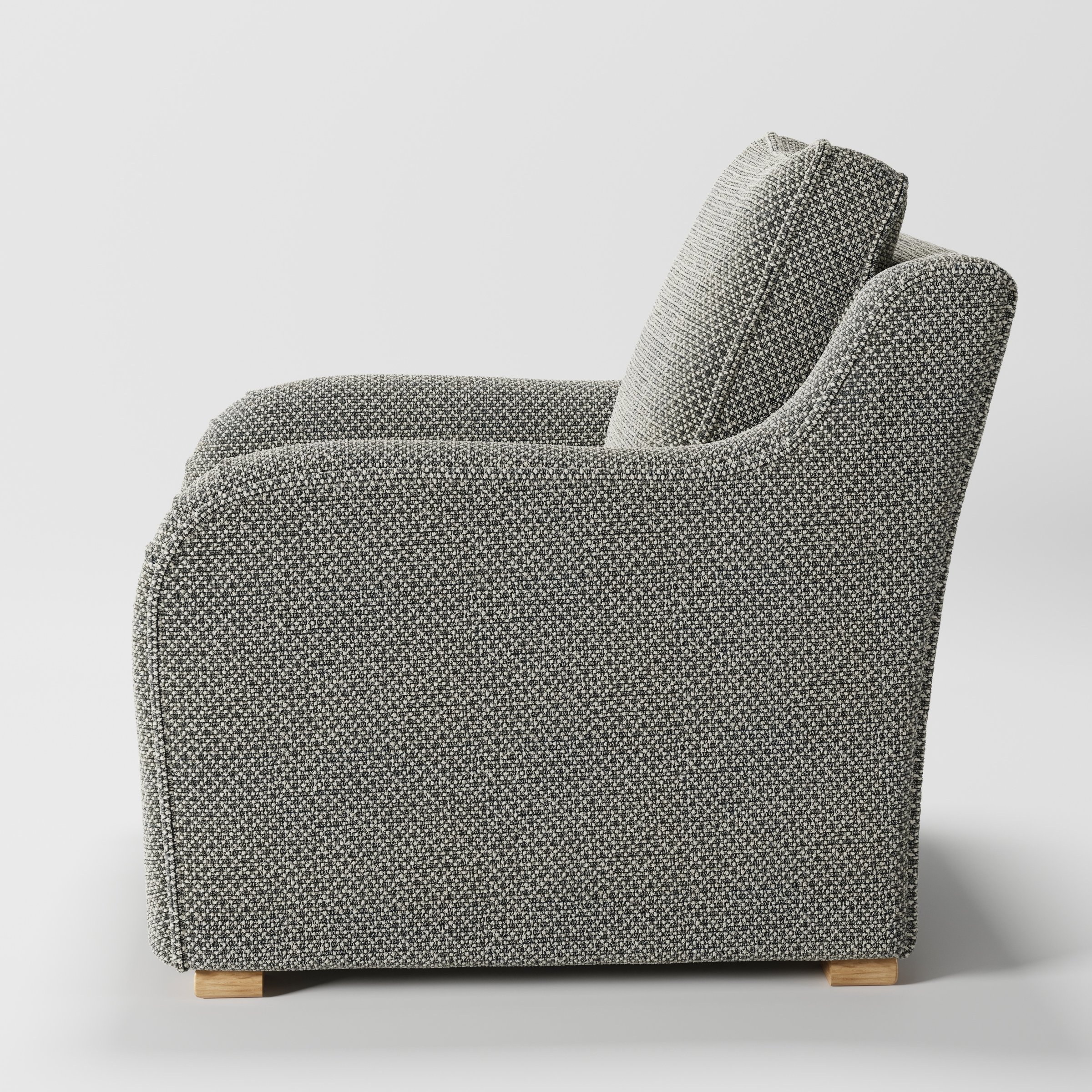 Cashel armchair in Rousay Wool Blend Tar and Chalk shown in side profile displaying proportions and overall silhouette.